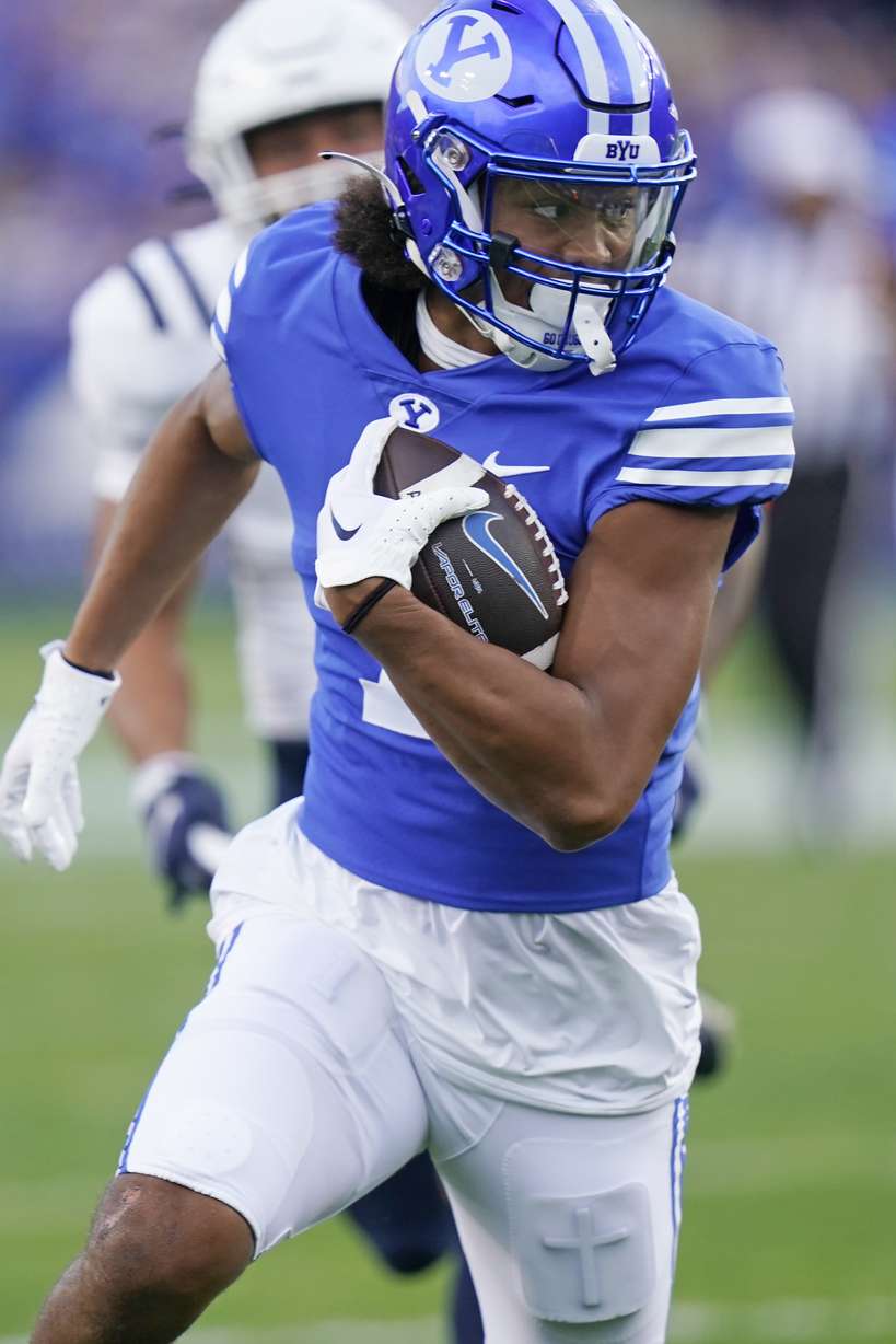BYU wide receiver Keanu Hill carries the ball for a touchdown against Utah State during the first half of an NCAA college football game Thursday, Sept. 29, 2022, in Provo.