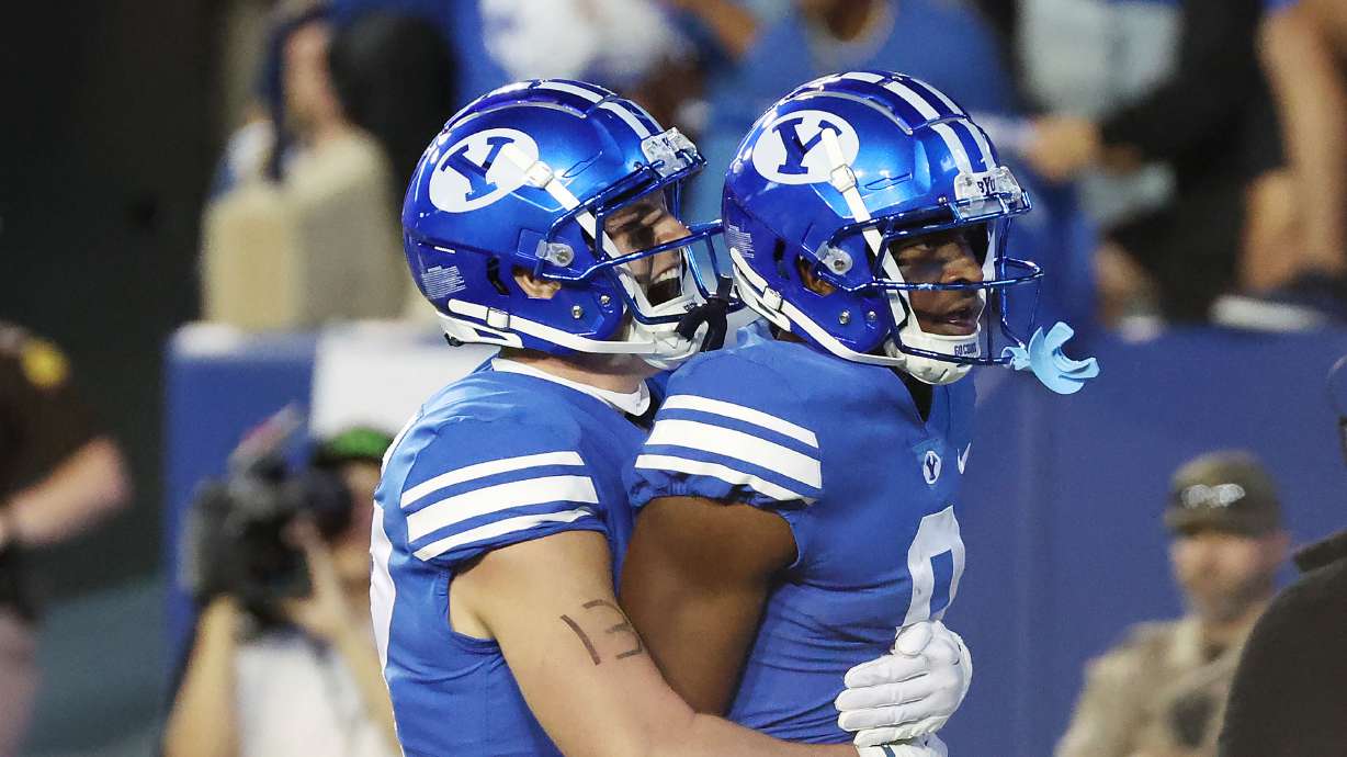 Brigham Young wide receiver Kody Epps (0) celebrates hs touchdown with Brigham Young fullback Masen Wake (13) in Provo on Thursday, Sept. 29, 2022.