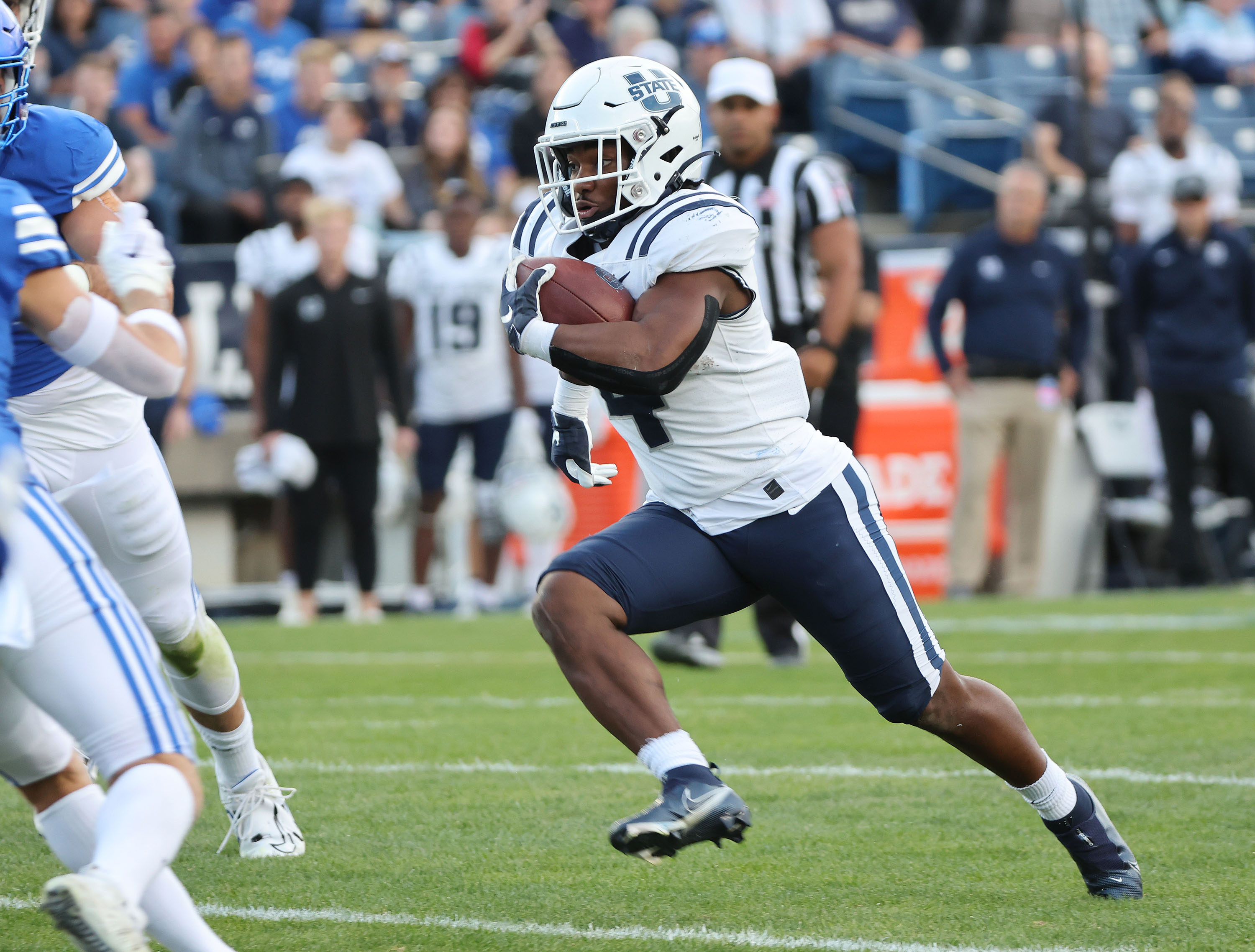 Utah State Aggies running back Calvin Tyler Jr. (4) runs against BYU in Provo on Thursday, Sept. 29, 2022.