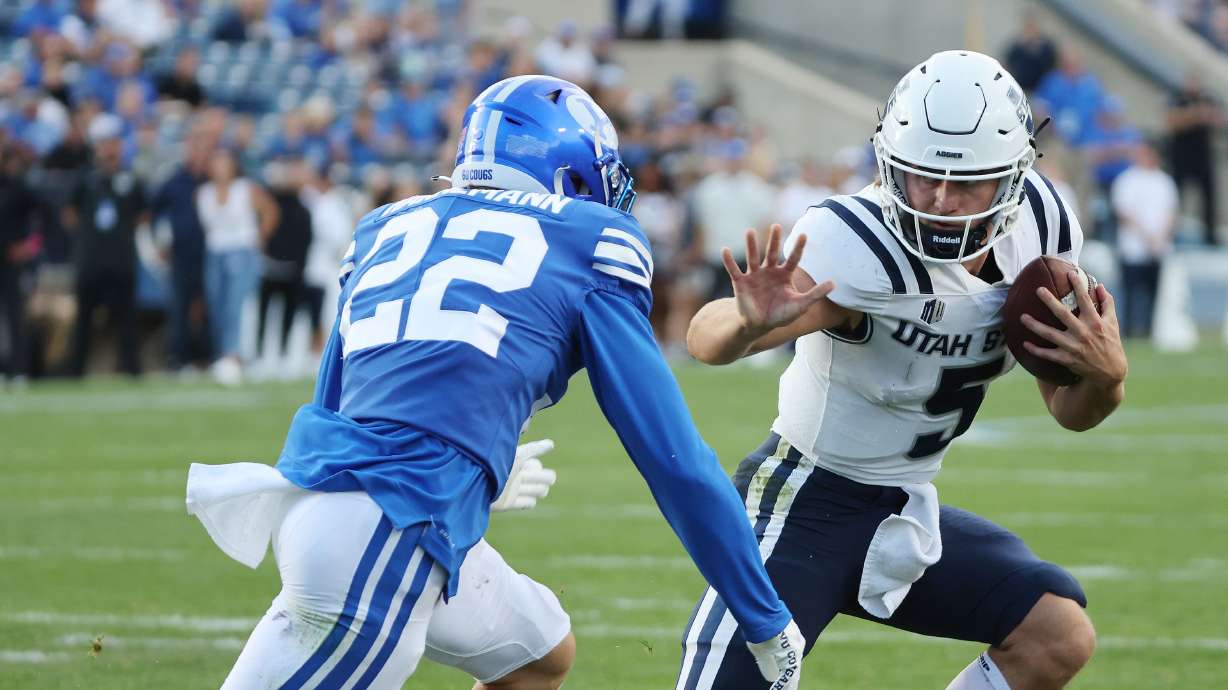 Utah State Aggies quarterback Cooper Legas (5) runs for a touchdown against BYU in Provo on Thursday, Sept. 29, 2022.