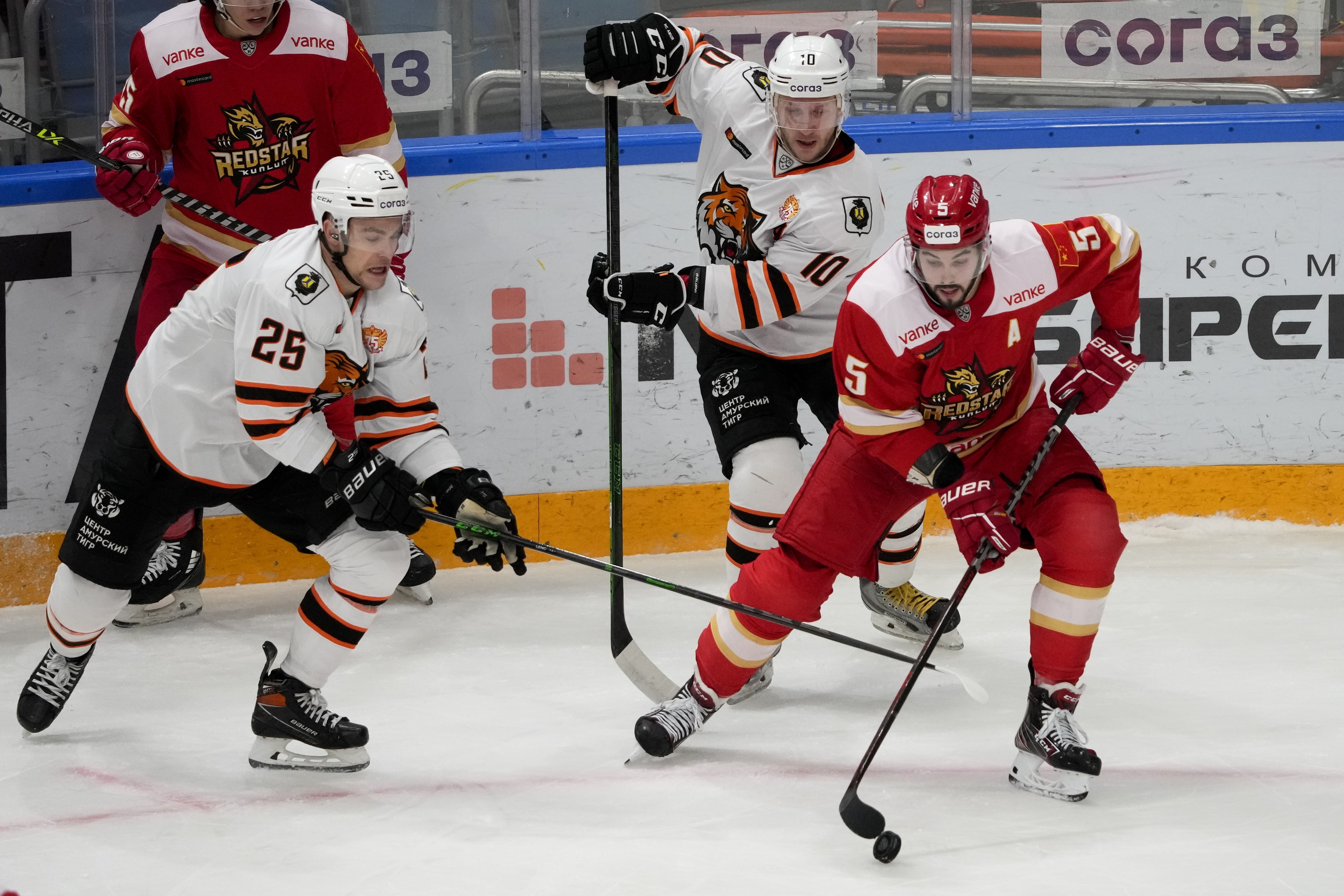FILE - Kunlun Red Star's Ryan Sproul, right, of Canada, fifths for the puck with Amur's Radan Lenc, left, during the Kontinental Hockey League ice hockey match between Kunlun Red Star Beijing and Amur Khabarovsk in Mytishchi, just outside Moscow, Russia, on Nov. 15, 2021. North Americans playing in the Russia-based KHL have been put in a difficult position amid calls from the U.S and Canadian governments for them to leave the country because of the war in Ukraine. 