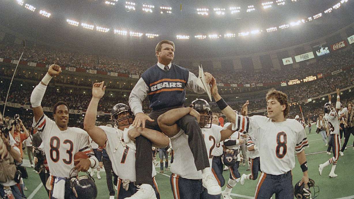 Chicago Bears head coach Mike Ditka is carried off the field by Steve McMichael and William Perry after the team won Super Bowl XX against the New England Patriots in New Orleans on Jan. 26, 1986. Ditka died on Friday at the age of 86.
