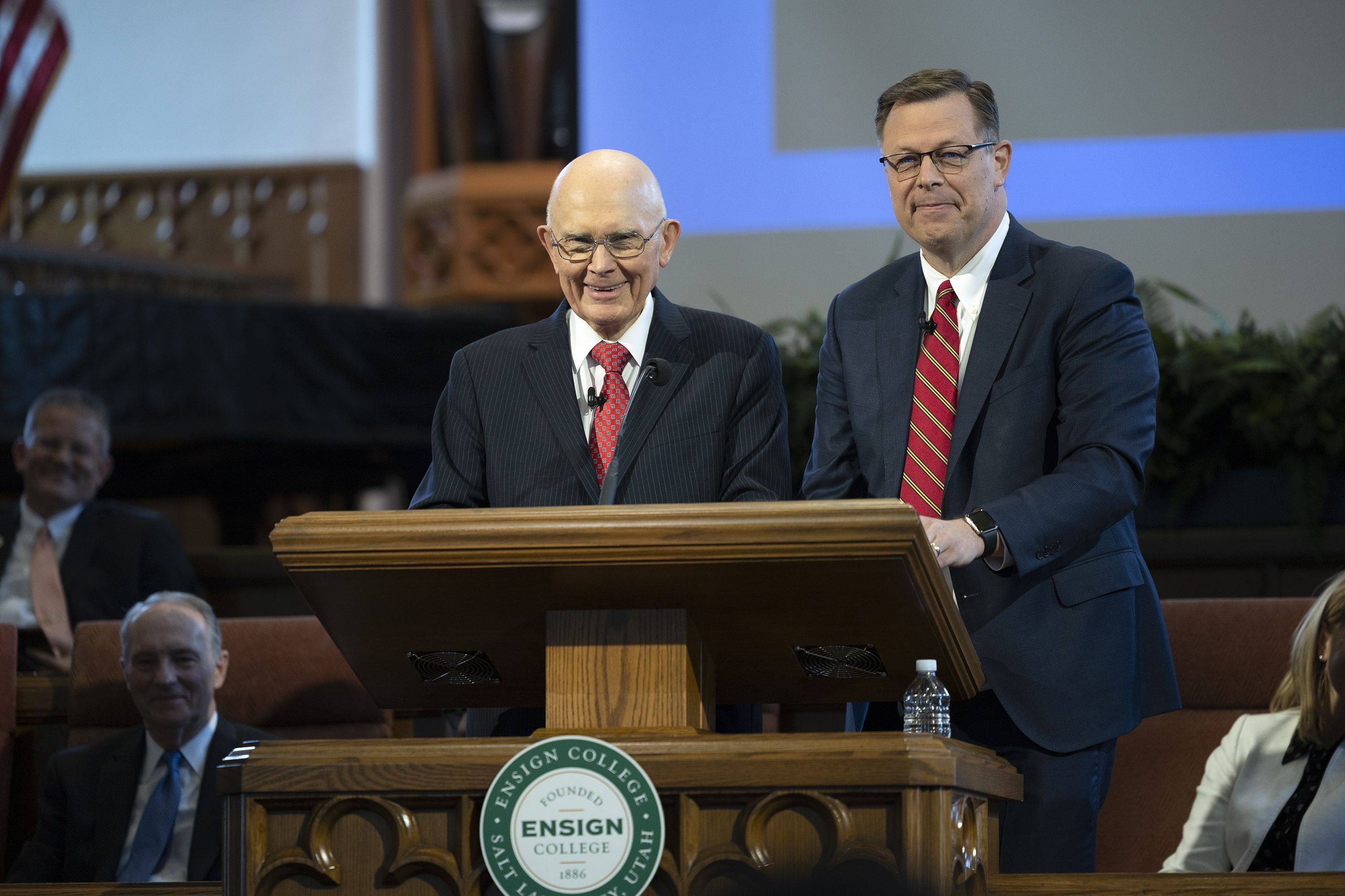 President Dallin H. Oaks, first counselor in the First Presidency of The Church of Jesus Christ of Latter-day Saints, left, and Elder Clark G. Gilbert, a general authority seventy and church commissioner of education, speak at an Ensign College devotional in the Assembly Hall on Temple Square in Salt Lake City on May 17.