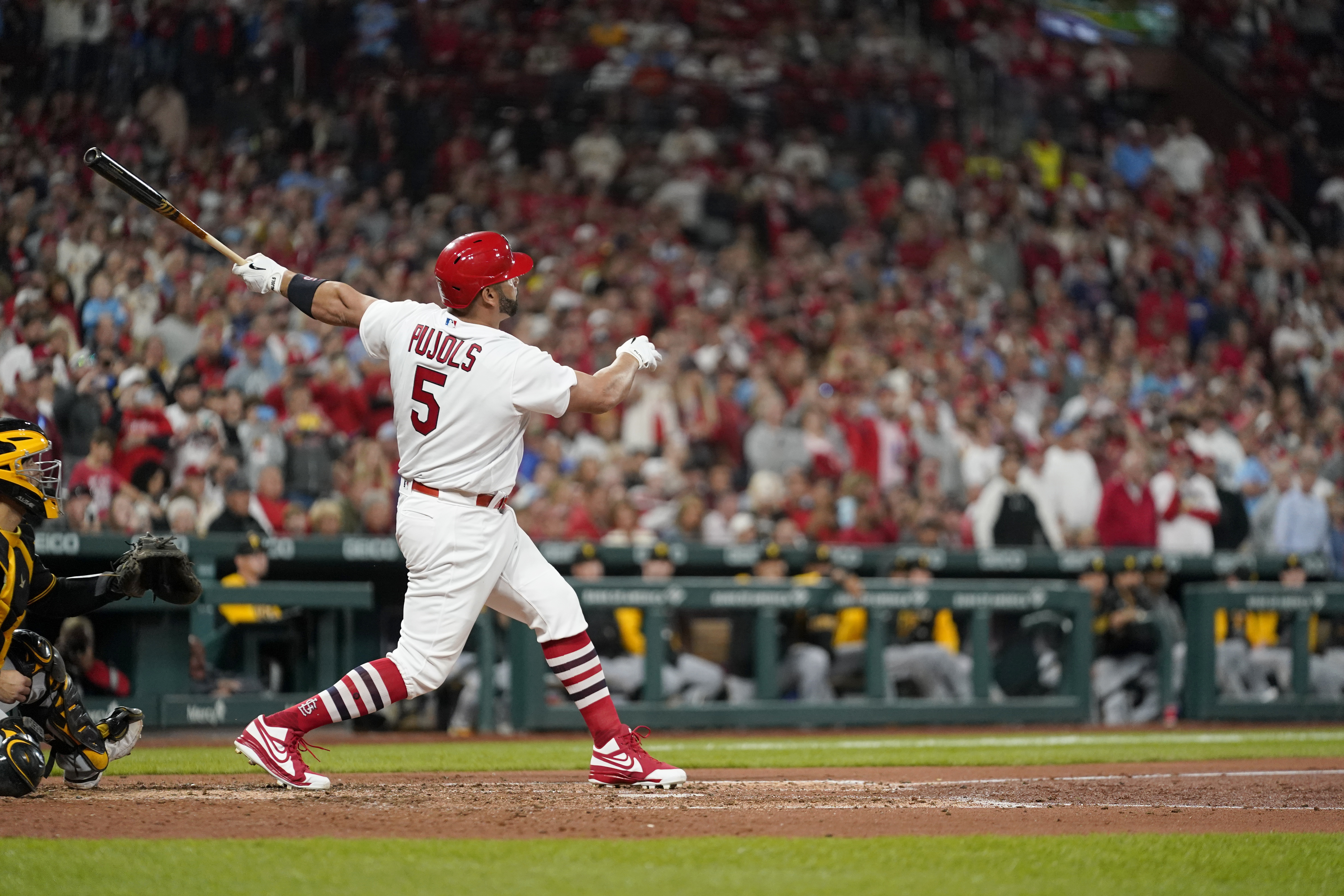 St. Louis Cardinals' Albert Pujols follows through on a solo home run during the fourth inning of a baseball game against the Pittsburgh Pirates Friday, Sept. 30, 2022, in St. Louis. 