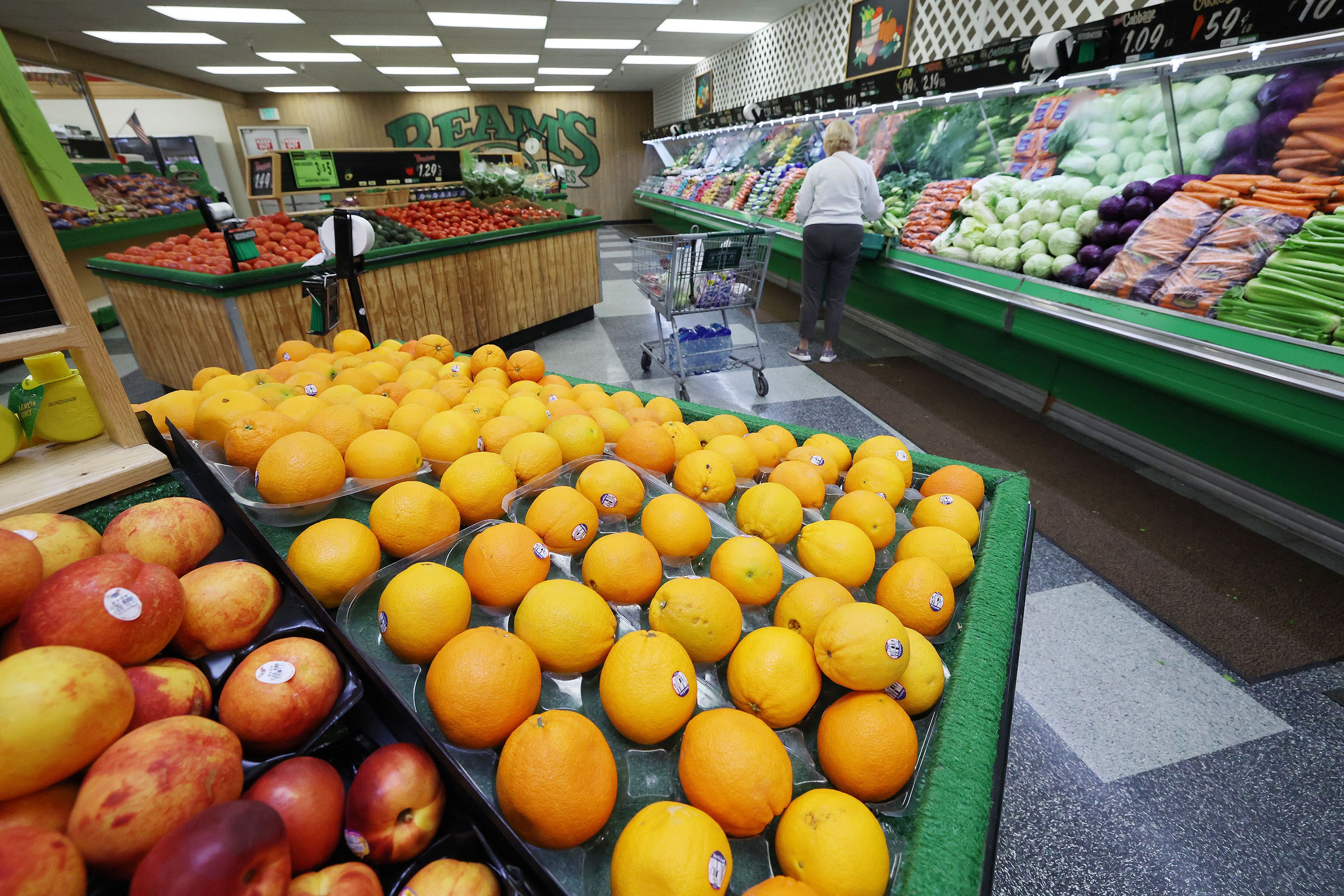 A shopper looks for produce at Reams Food Store in Sandy on Friday, Sept. 23.