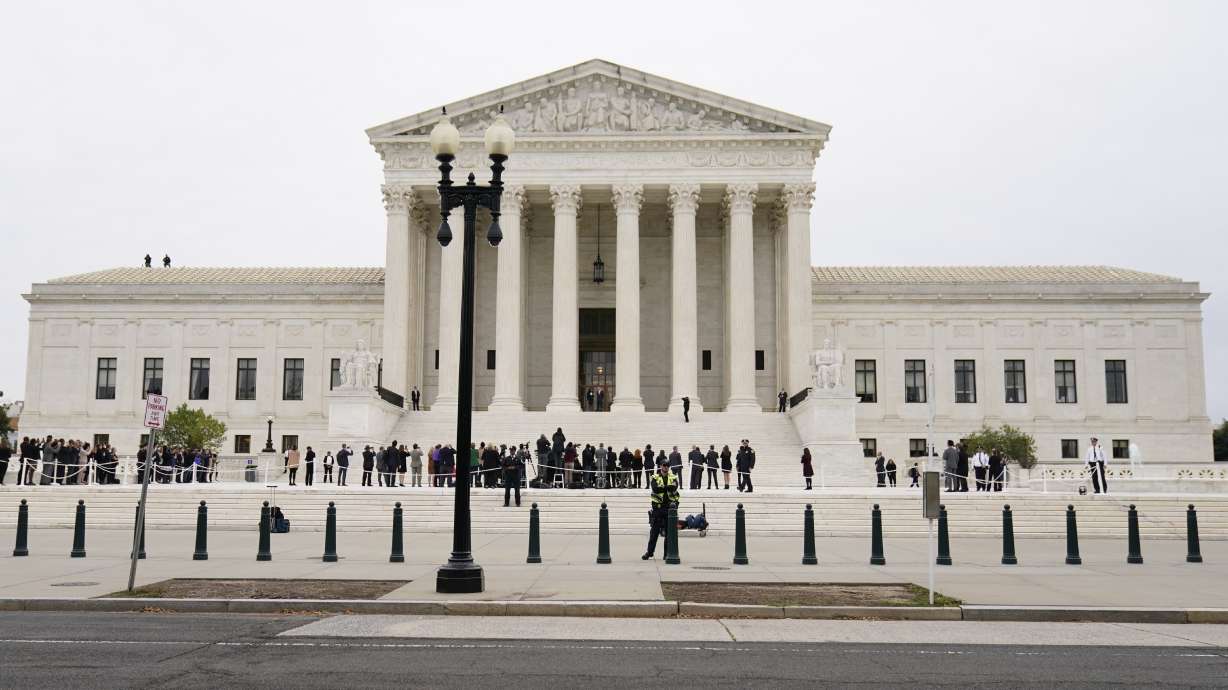 Supreme Court Associate Justice Ketanji Brown Jackson stands outside the Supreme Court, at the top of the steps, with Chief Justice of the United States John Roberts, following her formal investiture ceremony at the Supreme Court in Washington, Friday.