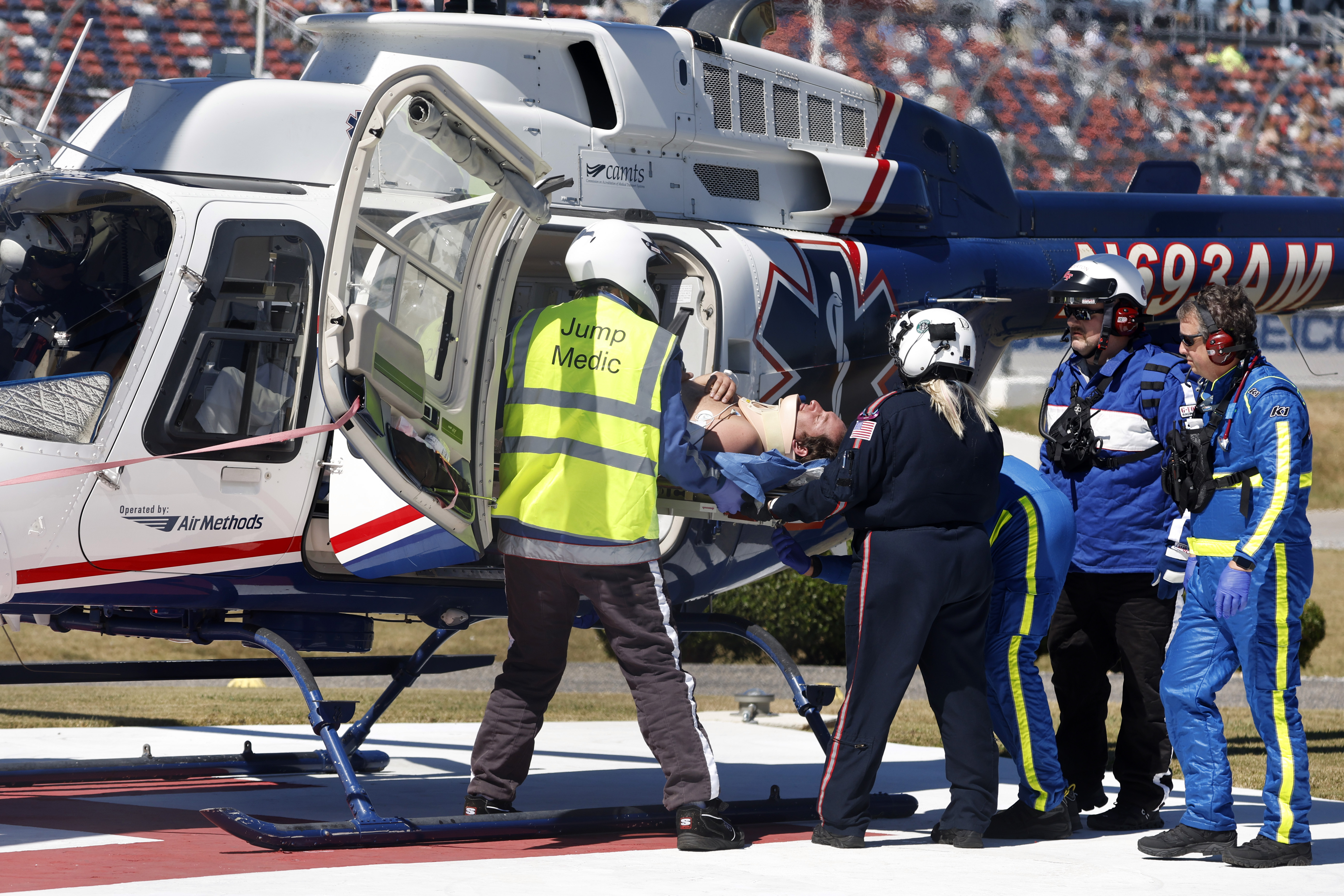 Driver Jordan Anderson is loaded into a helicopter after a fiery crash during the NASCAR Trucks Chevrolet Silverado 250 auto race, Saturday, Oct. 1, 2022, in Talladega, Ala.