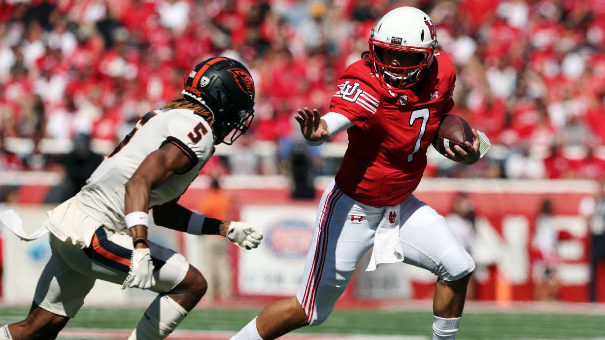 Utah Utes quarterback Cameron Rising (7) reaches out to stiff-arm Oregon State Beavers defensive back Alex Austin (5) during a run as Utah and Oregon State play at Rice Eccles Stadium in Salt Lake City on Saturday, Oct. 1, 2022.