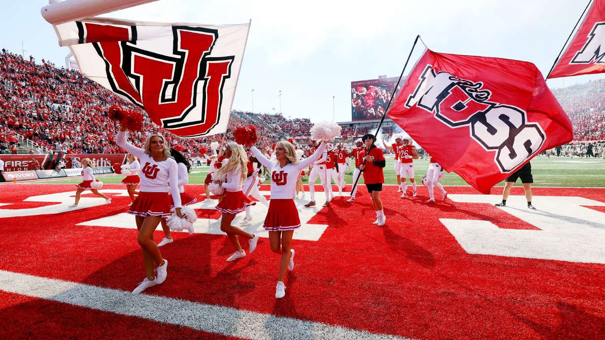 Utah cheerleaders run onto the field before the start of the game as Utah and Oregon State prepare to play at Rice Eccles Stadium in Salt Lake City on Saturday, Oct. 1, 2022.