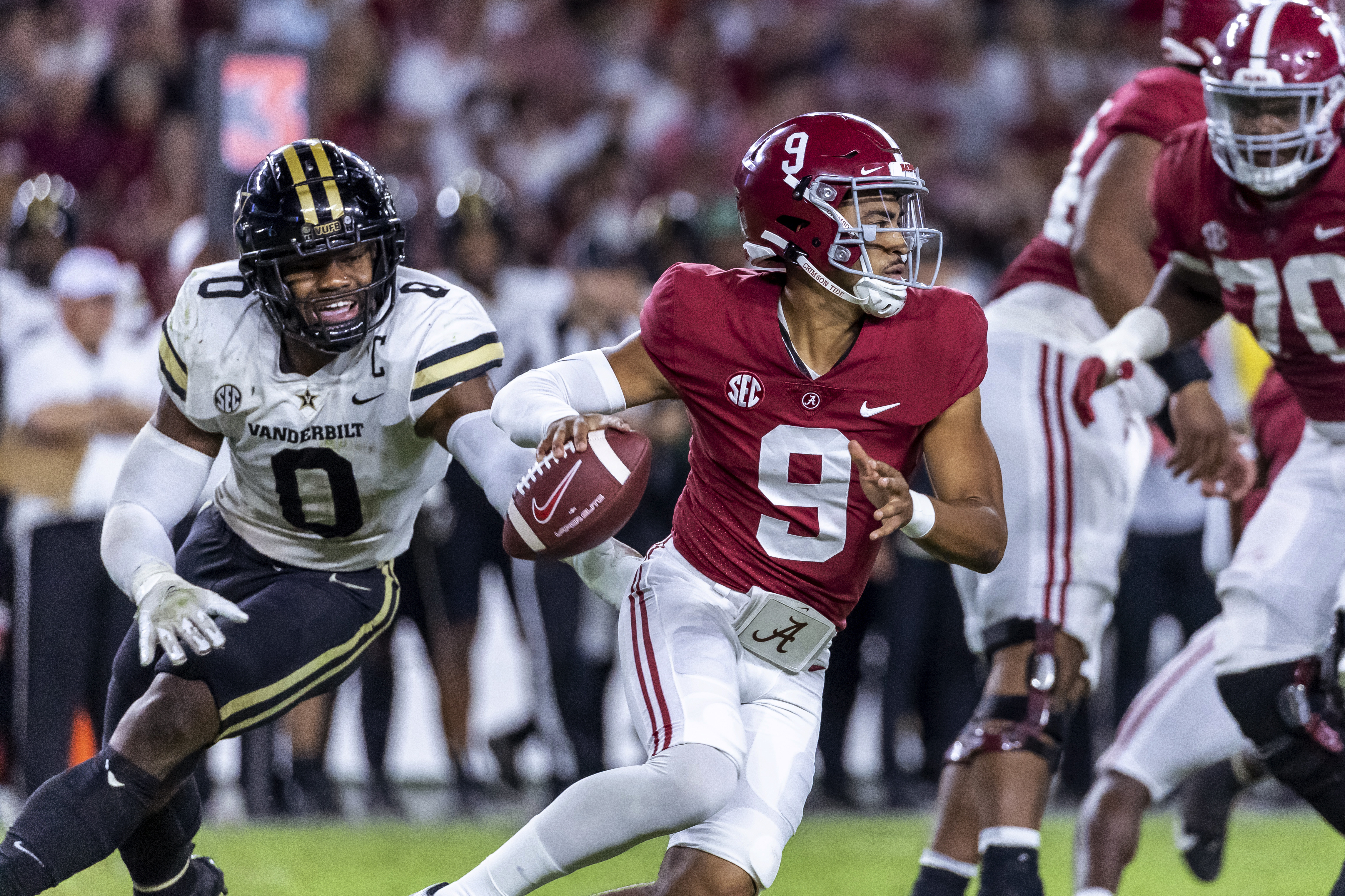 Alabama quarterback Bryce Young (9) works away from pressure from Vanderbilt linebacker Anfernee Orji (0) during the second half of an NCAA college football game Saturday, Sept. 24, 2022, in Tuscaloosa, Ala. 