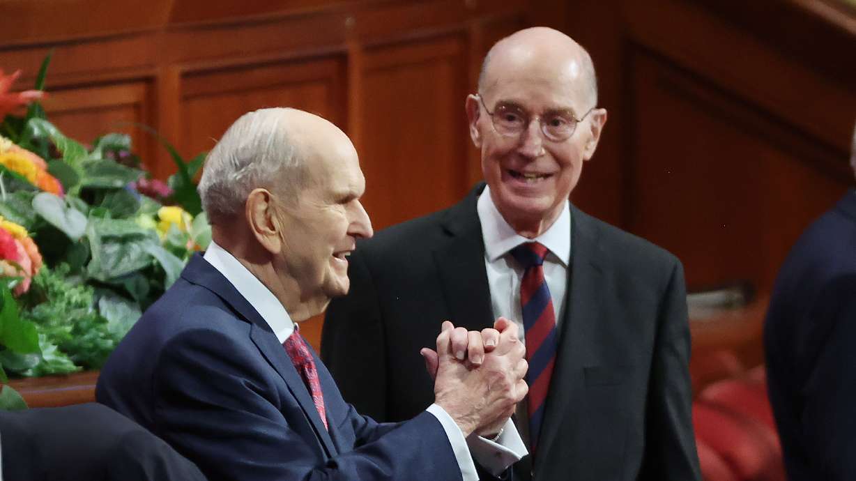 President Russell M. Nelson, president of The Church of Jesus Christ of Latter-day Saints, motions to attendees during the Sunday morning session of the 192nd Semiannual General Conference of The Church of Jesus Christ of Latter-day Saints in Salt Lake City. He announced 18 new temples during the Sunday afternoon session of conference.