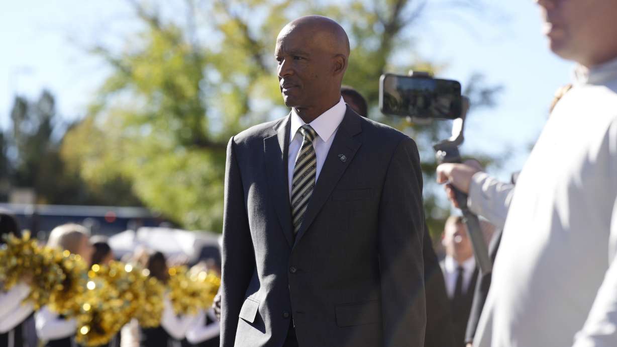 Colorado head coach Karl Dorrell arrives with his players at Folsom Field before an NCAA college football game against UCLA Saturday, Sept. 24, 2022, in Boulder, Colo.