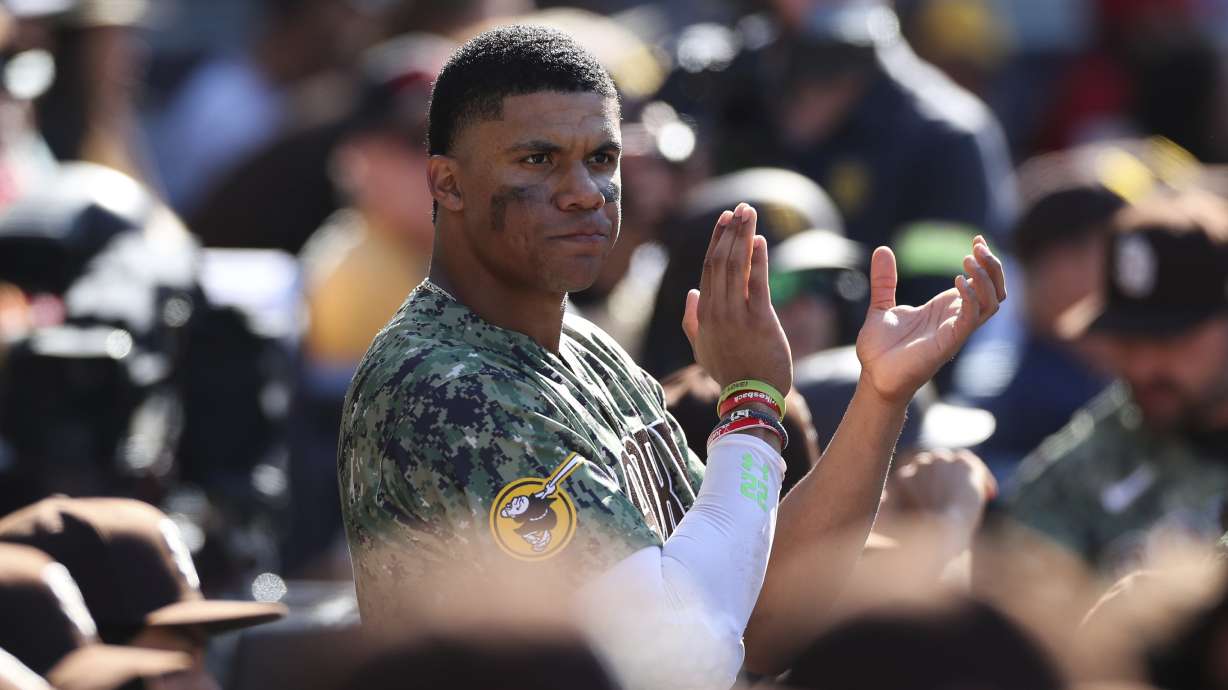 San Diego Padres' Juan Soto claps after the team clinched a playoff spot in the seventh inning of a baseball game against the Chicago White Sox, Sunday, Oct. 2, 2022, in San Diego.
