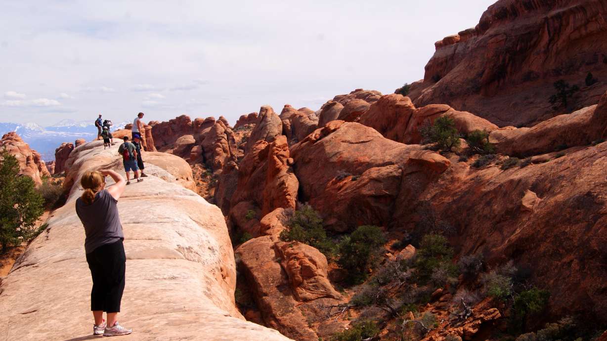 Visitors hike Arches National Park in 2020. A new shuttle pilot program to handle some of the park's traffic is poised to begin later this year, after receiving state and federal funding. Grand County leaders are expected to add local funding Tuesday.