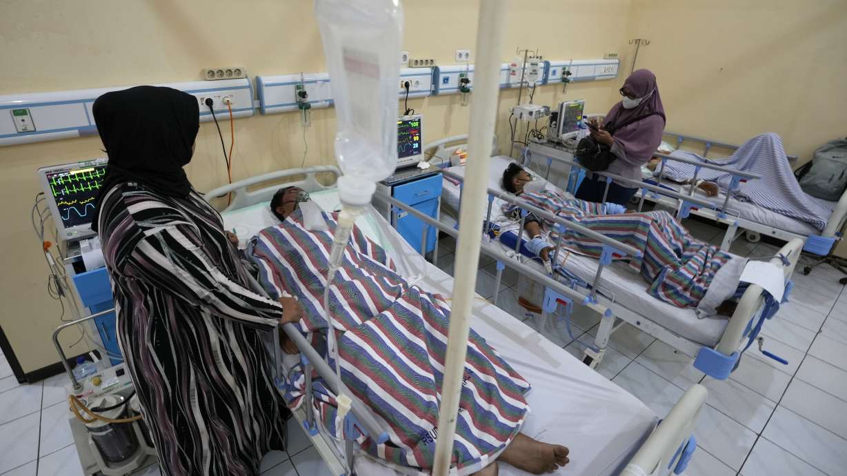 Relatives stand nearby as survivors of Saturday's soccer riots are treated at a hospital in Malang, East Java, Indonesia, Monday Oct. 3, 2022. Police firing tear gas at Saturday night's match between host Arema FC of East Java's Malang city and Persebaya Surabaya in an attempt to stop violence triggered a disastrous crush of fans making a panicked, chaotic run for the exits, leaving a large number of people dead, most of them trampled upon or suffocated.
