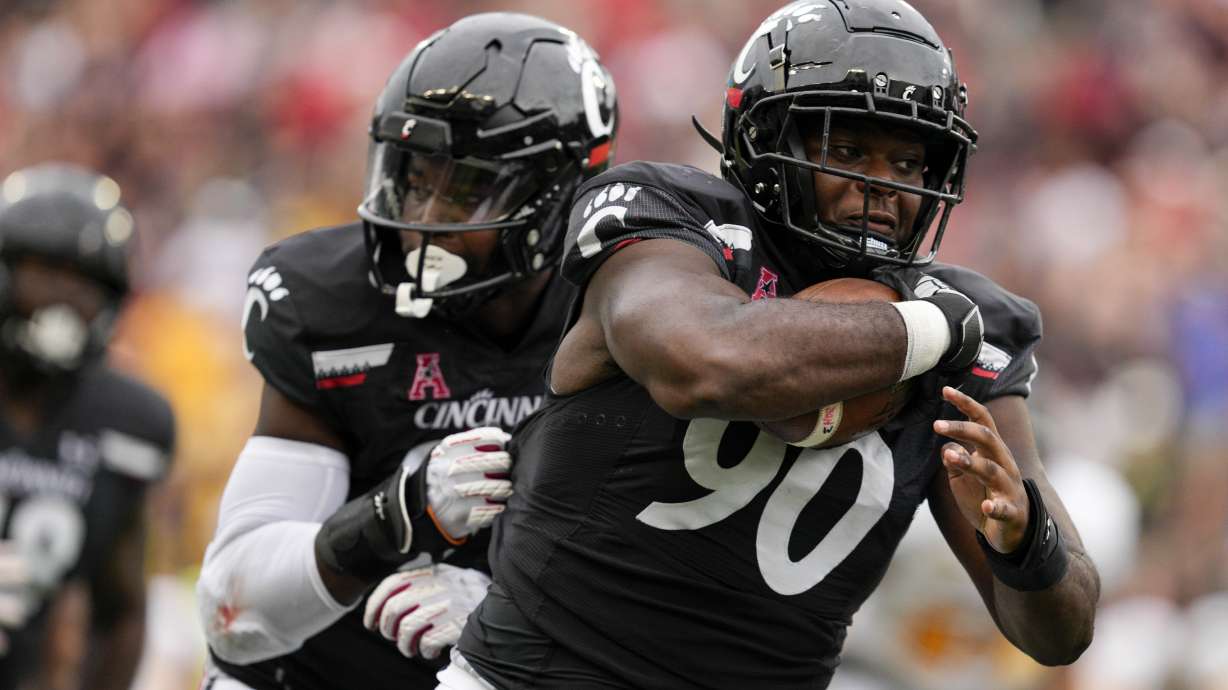 Cincinnati defensive lineman Jabari Taylor (90) runs for a touchdown after recovering a fumble during the second half of an NCAA college football game against Kennesaw State, Saturday, Sept. 10, 2022, in Cincinnati.