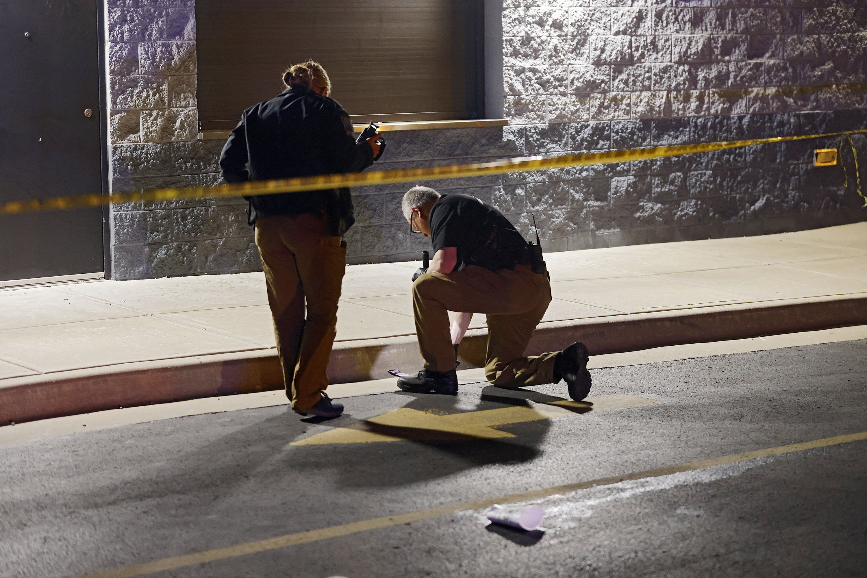 Tulsa Police officers investigate the area outside of the McLain High School football stadium after a shooting during a football game left one teen dead and another injured Friday, Sept. 30, 2022 in Tulsa, Okla. Police say a teenager was killed and another was wounded in a shooting at a high school homecoming football game in Oklahoma Friday night. 