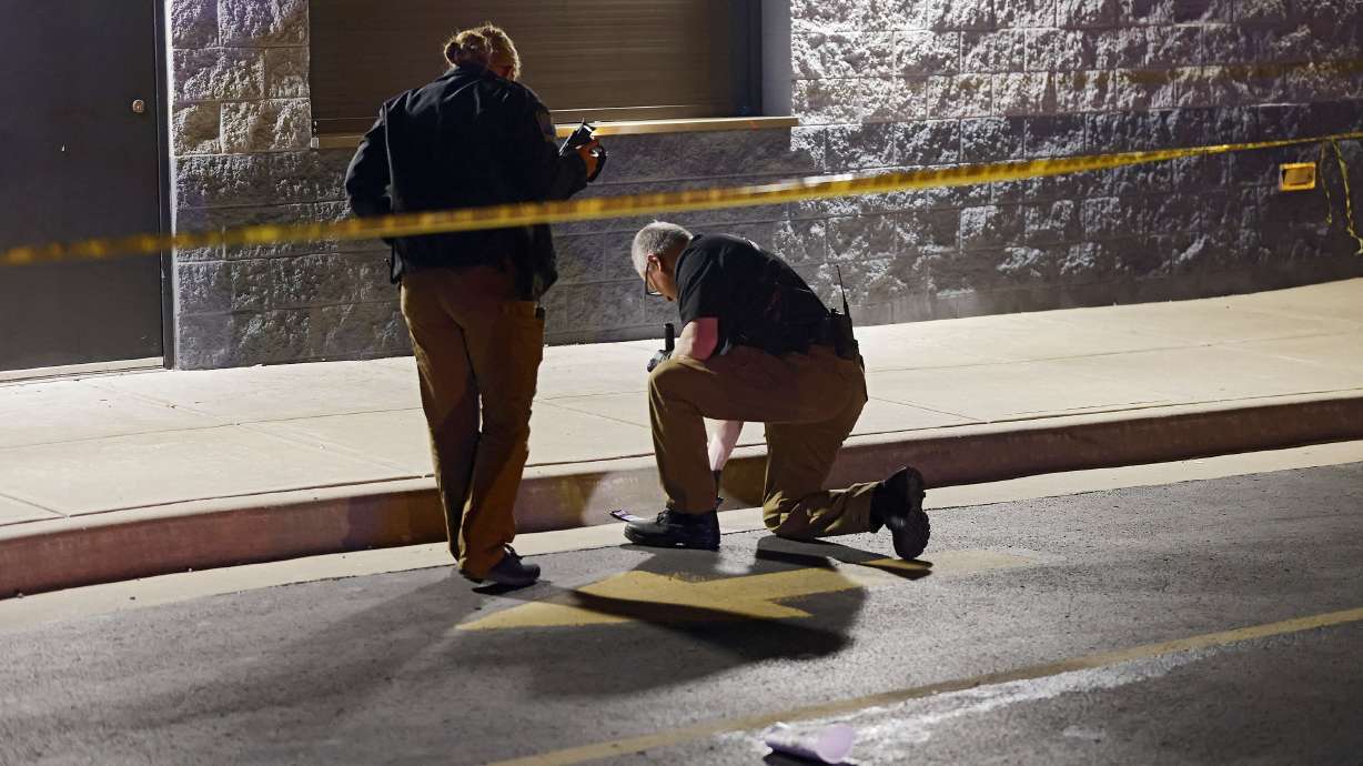 Tulsa Police officers investigate the area outside of the McLain High School football stadium after a shooting during a football game left one teen dead and another injured Friday, Sept. 30, 2022 in Tulsa, Okla. Police say a teenager was killed and another was wounded in a shooting at a high school homecoming football game in Oklahoma Friday night.