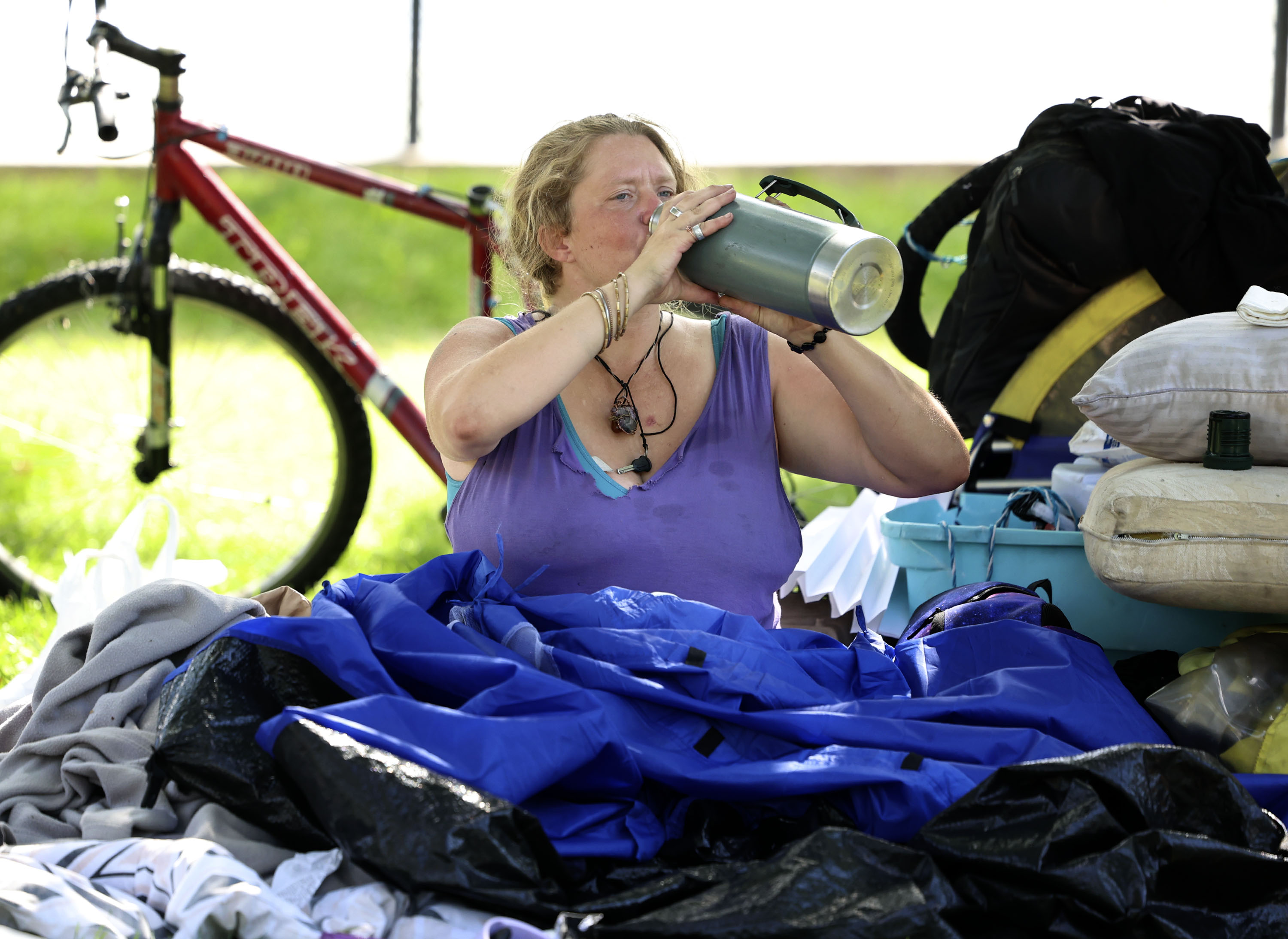 Crystil Carter drinks water during record-breaking heat at Liberty Park in Salt Lake City on Sept. 7. Last month was the hottest September on record, according to National Weather Service data.