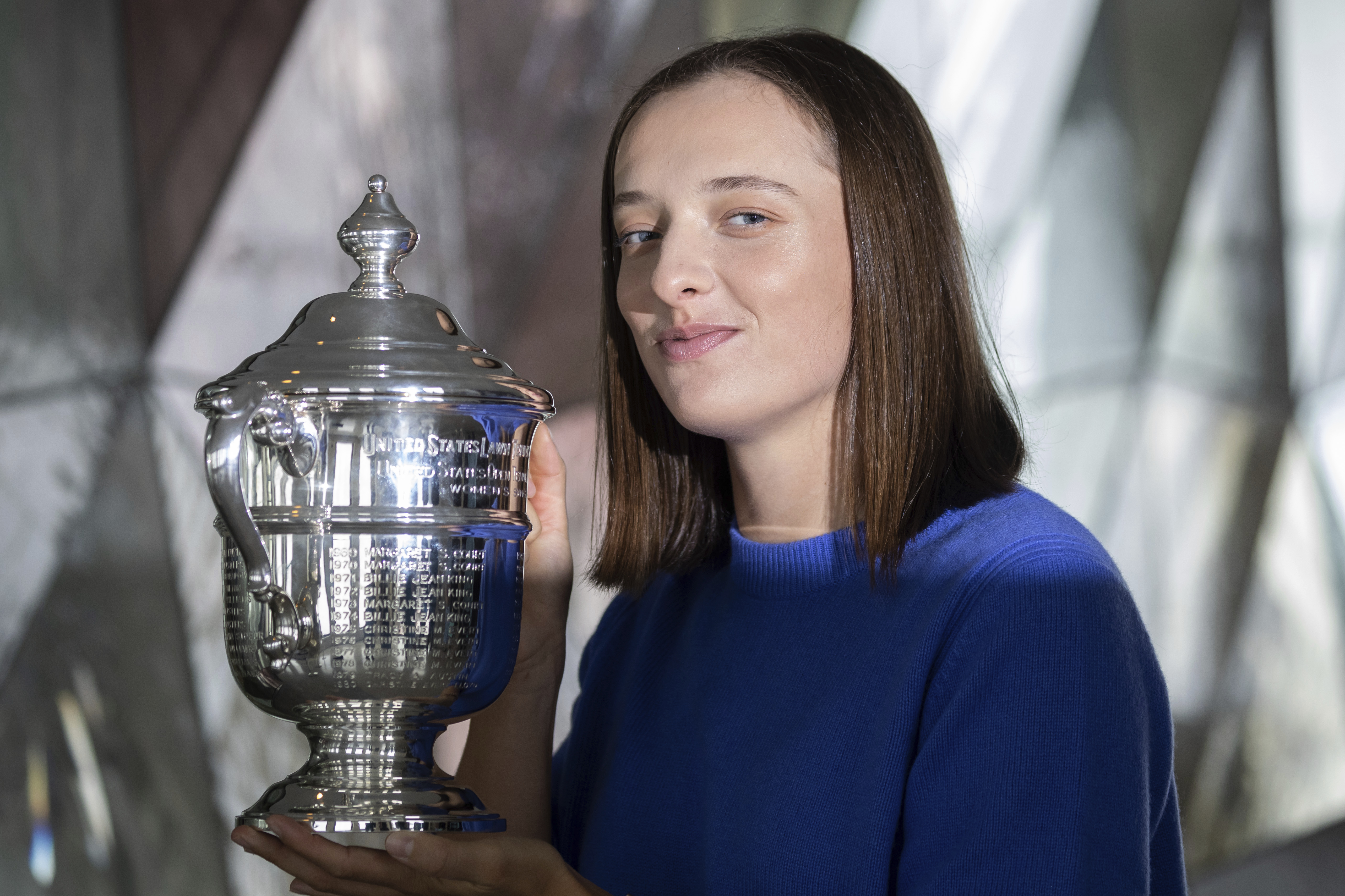 FILE - U.S. Open women's singles tennis champion Iga Swiatek poses at "Top of the Rock," in New York's Rockefeller Center, Monday, Sept. 12, 2022, in New York. Top-ranked Iga Swiatek will not play for Poland in the Billie Jean King Cup and complained Monday, Oct. 3, 2022, about that event being scheduled too close to the WTA Finals. 