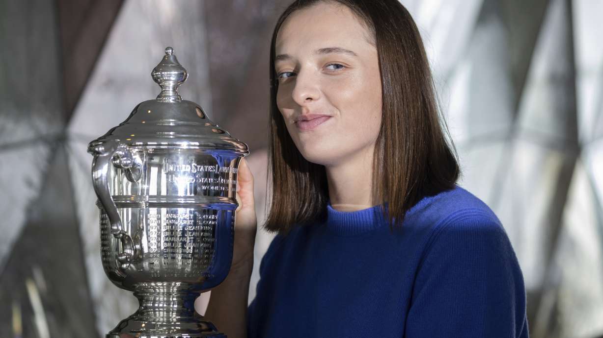 FILE - U.S. Open women's singles tennis champion Iga Swiatek poses at "Top of the Rock," in New York's Rockefeller Center, Monday, Sept. 12, 2022, in New York. Top-ranked Iga Swiatek will not play for Poland in the Billie Jean King Cup and complained Monday, Oct. 3, 2022, about that event being scheduled too close to the WTA Finals.