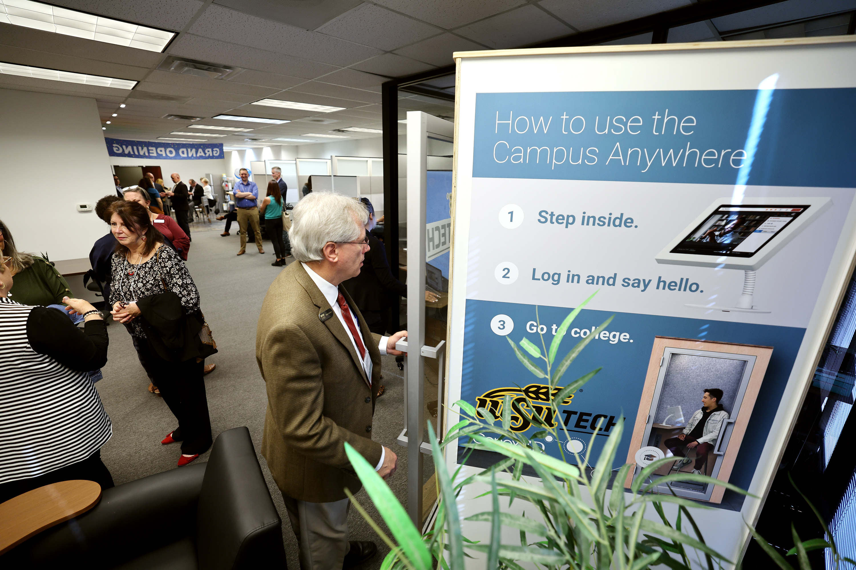 Ryan Carstens, of BYU Pathways, steps into a single privacy booth as invited guests attend the grand opening of ConexED’s showroom, which features its new Campus Anywhere technology, in Salt Lake City on Monday.