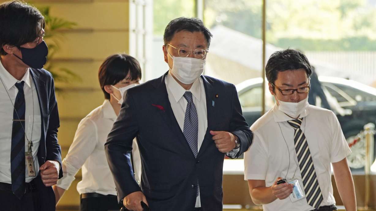 Japan's Chief Cabinet Secretary Hirokazu Matsuno, center, arrives at the prime minister's office in Tokyo on Tuesday. South Korea says North Korea has fired a ballistic missile toward its eastern waters.