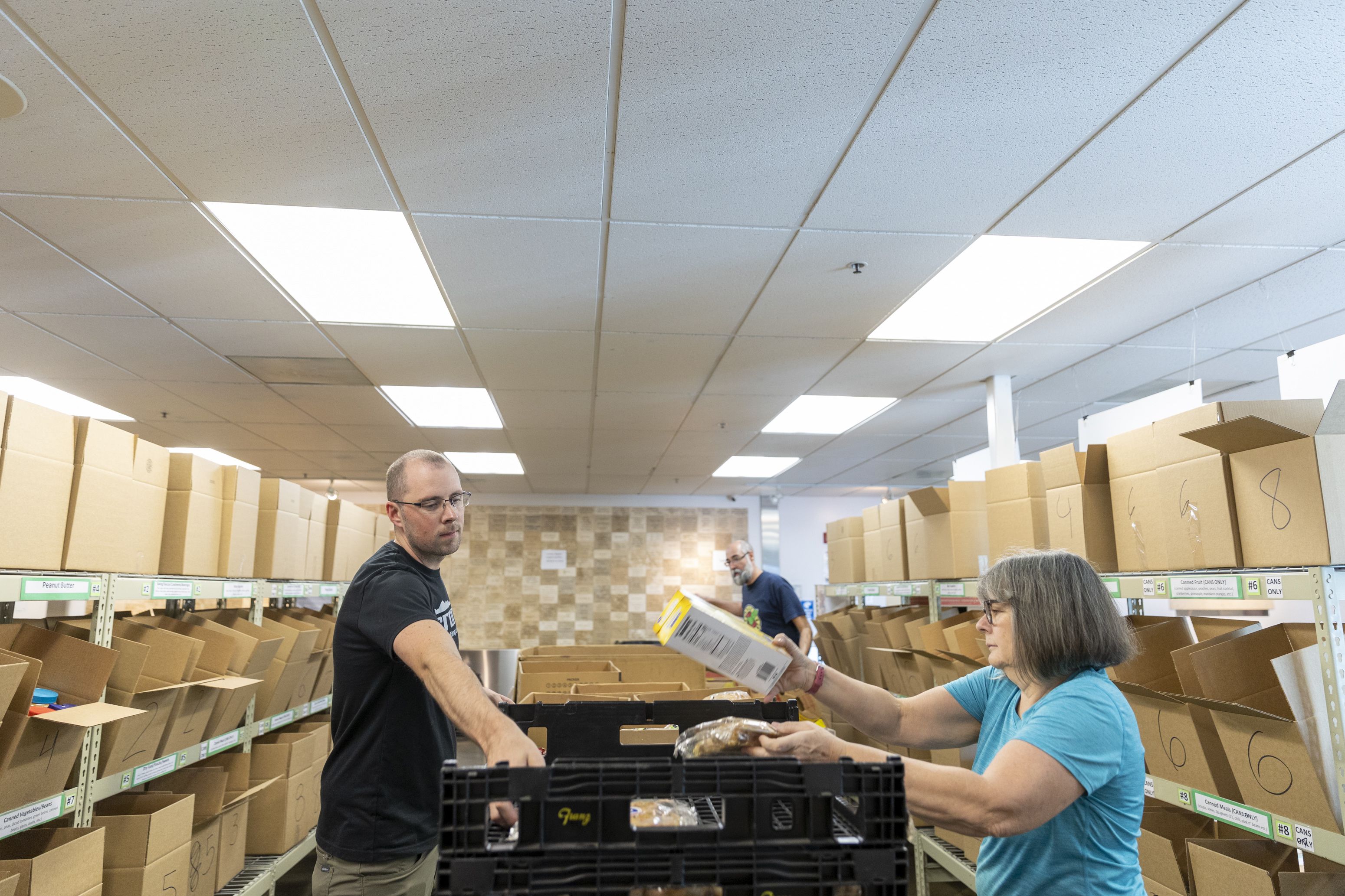 Tylar Hiss, left, and Melanie Jones volunteer at the Utah Food Bank in Salt Lake City on Monday.
