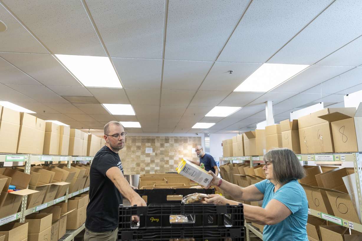 Tylar Hiss, left, and Melanie Jones volunteer at the Utah Food Bank in Salt Lake City on Monday.