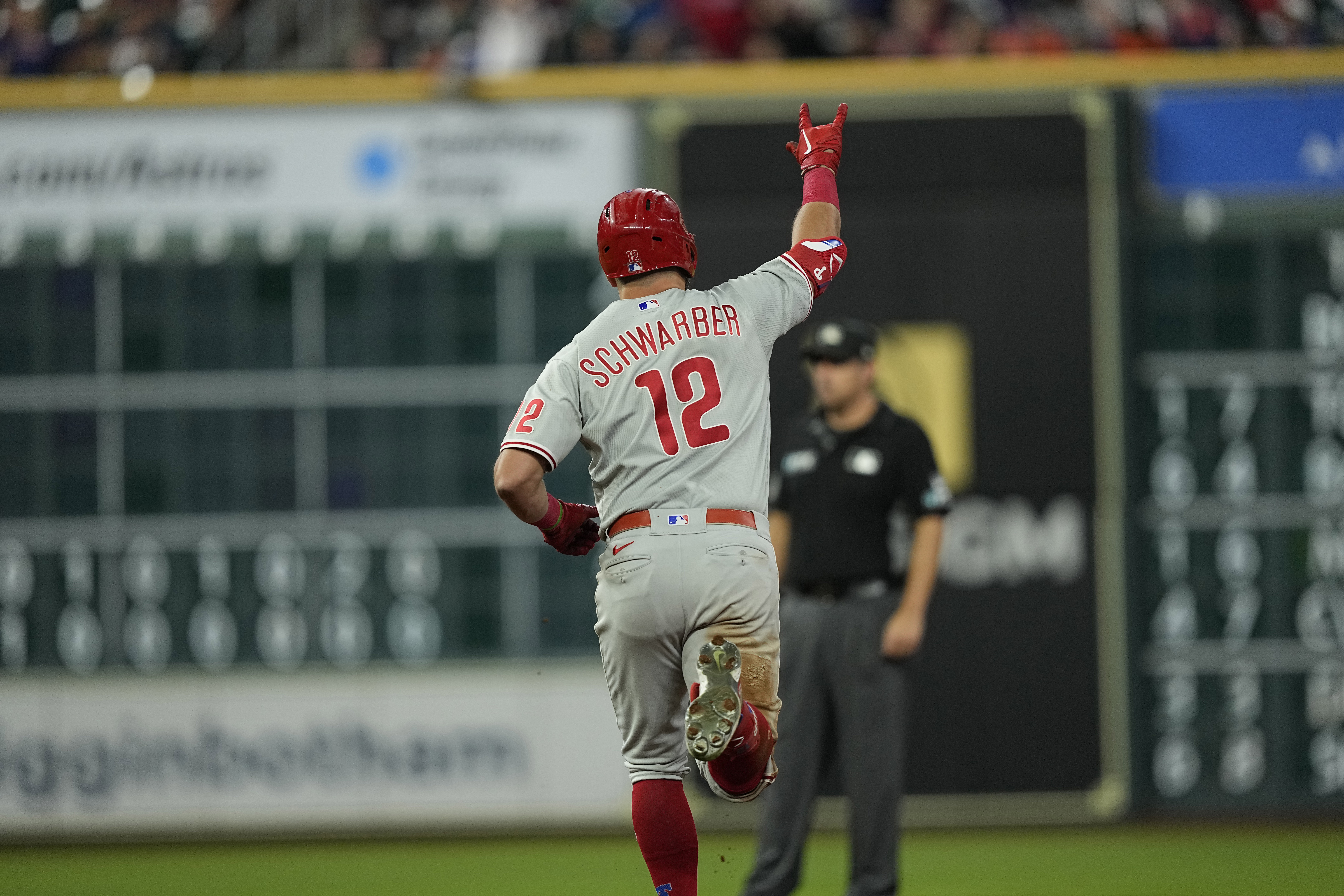 Philadelphia Phillies' Kyle Schwarber (12) celebrates after hitting a home run against the Houston Astros during the eighth inning of a baseball game Monday, Oct. 3, 2022, in Houston.