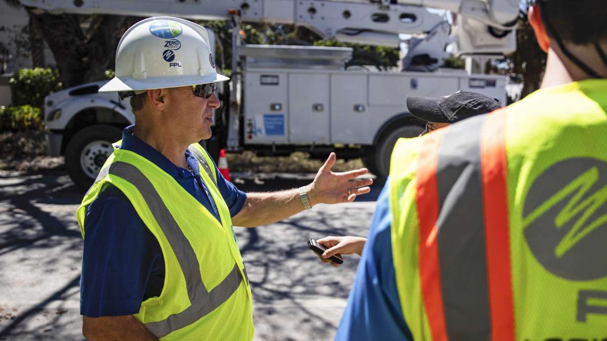 Florida Power and Light CEO Eric Silagy visits workers restoring power in Naples, Fla., on Monday. Silagy says that he expects crews to be finished restoring power to habitable homes impacted by Hurricane Ian by the end of the week.