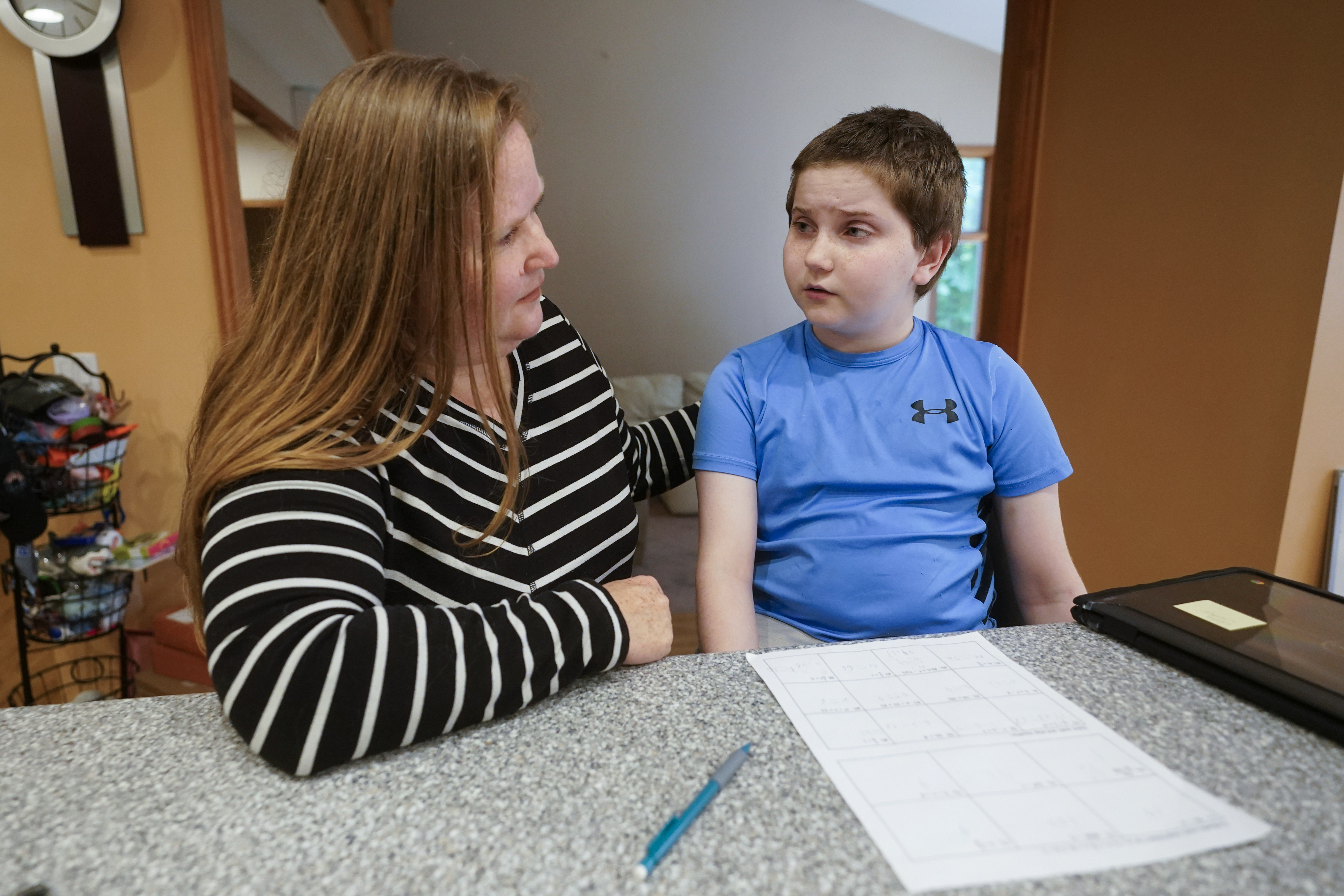Lisa Manwell helps her son John Jinks, 12, with learning at their home in Canton, Mich., Sept. 21. Manwell says her son was improperly removed from his classroom last year because of behaviors that stemmed from his disability.