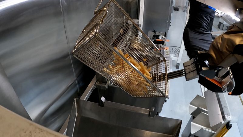 The Flippy 2 robot takes fries out of a vat of oil at a lab of manufacturer Miso Robotics Inc. in Pasadena, California, Sept. 27.
