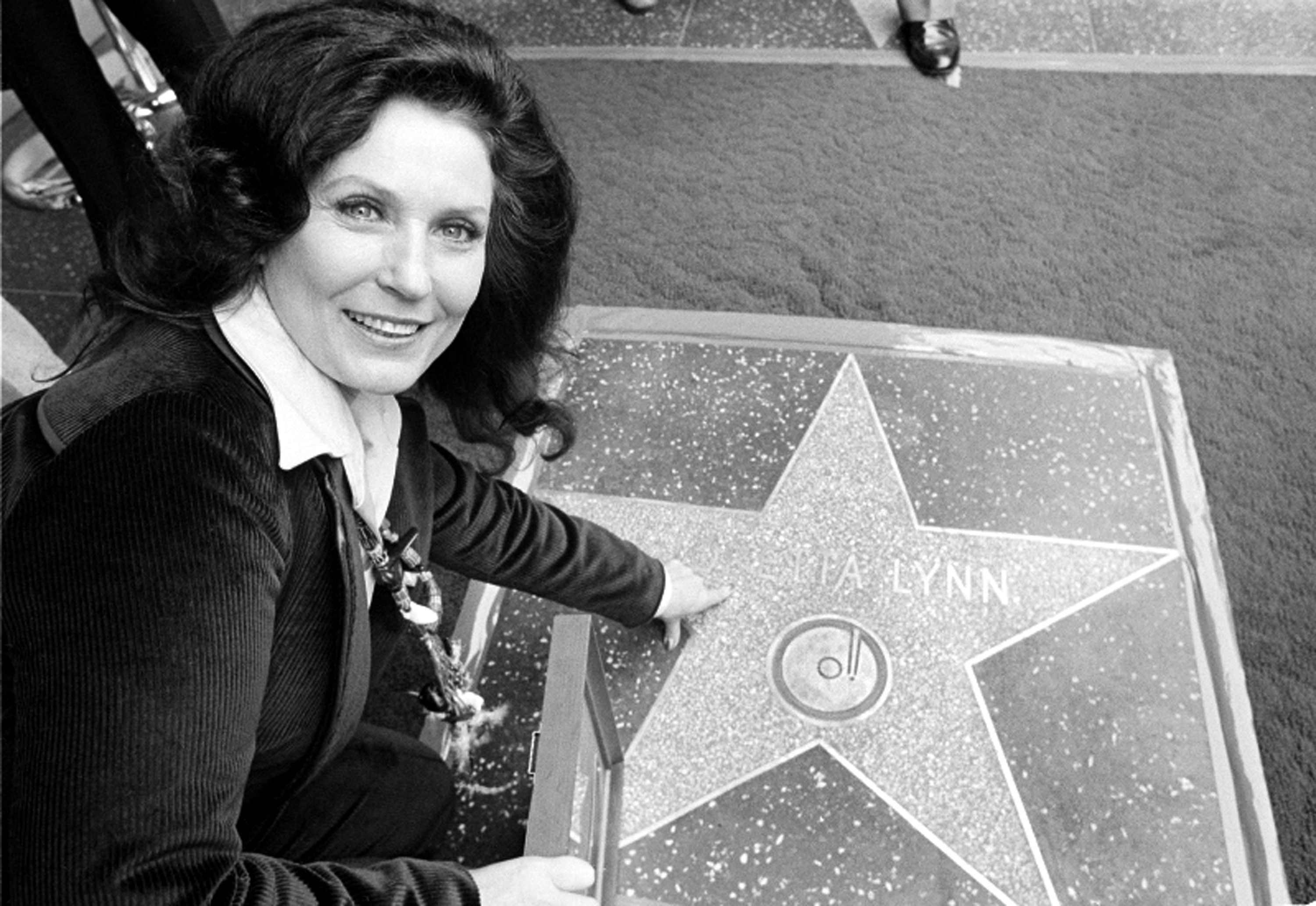 Country music singer Loretta Lynn points to her Hollywood Walk of Fame star during induction ceremonies in Hollywood, Calif., on Feb. 8, 1978.