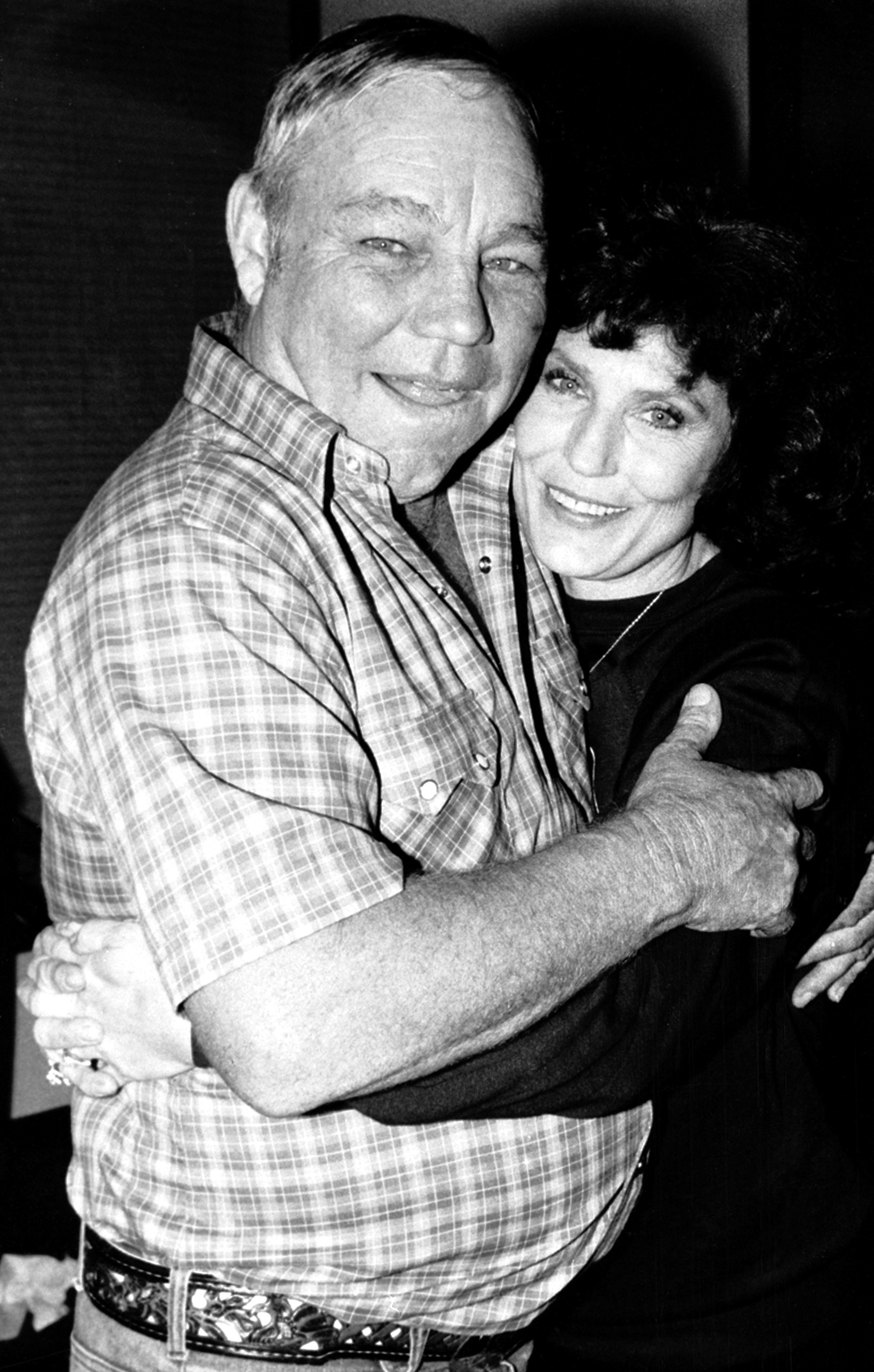 Country music singer Loretta Lynn embraces her husband, Oliver "Mooney" Lynn, during rehearsal for her New York debut, on Oct. 21, 1982.