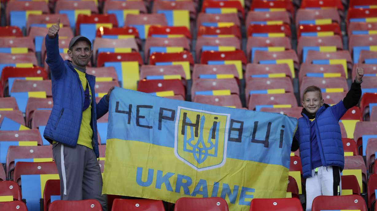 Ukrainian fans cheer prior to the star of the UEFA Nations League soccer match between Scotland and Ukraine, at Hampden Park, in Glasgow, Scotland, Wednesday, Sept. 21, 2022.