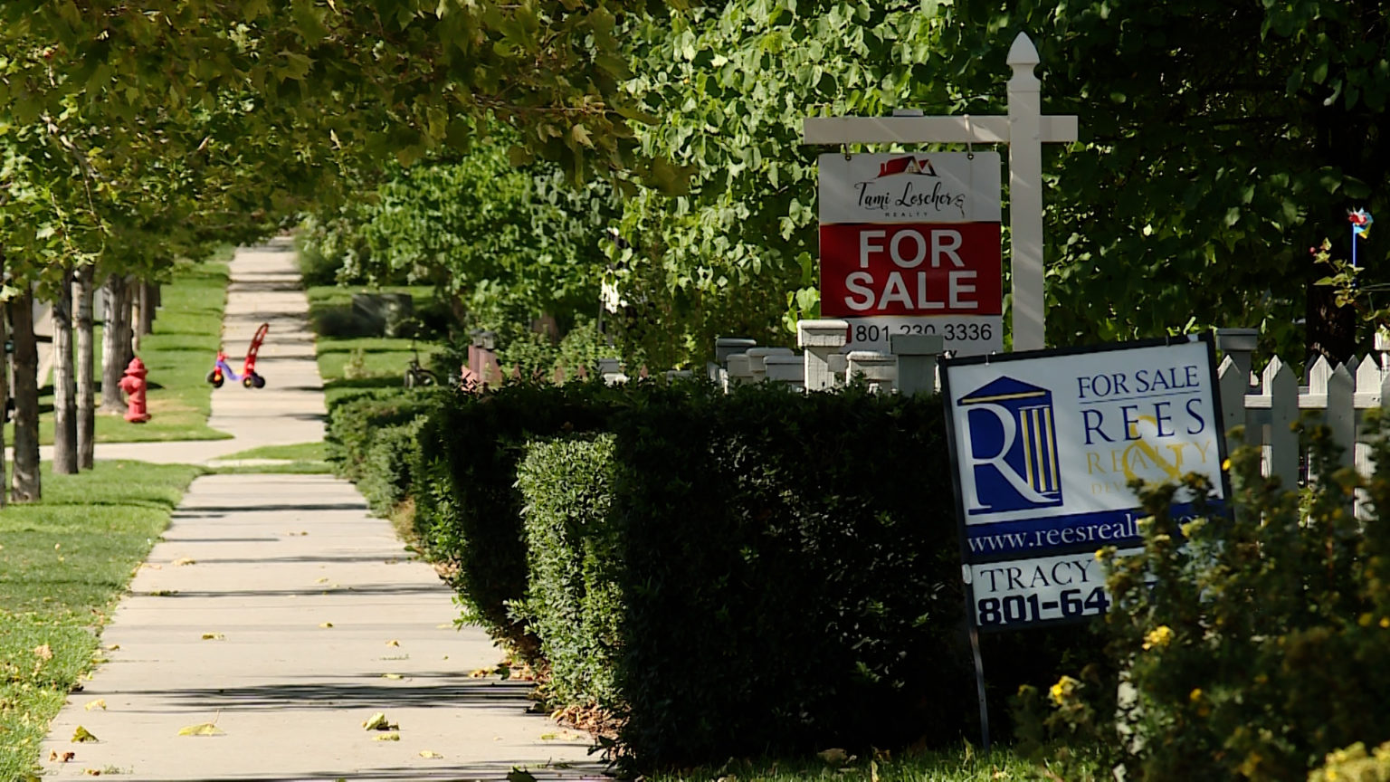 Homes for sale are shown. A Utah Association of Realtors report shows home sales in August were down nearly 24% compared to a year before.