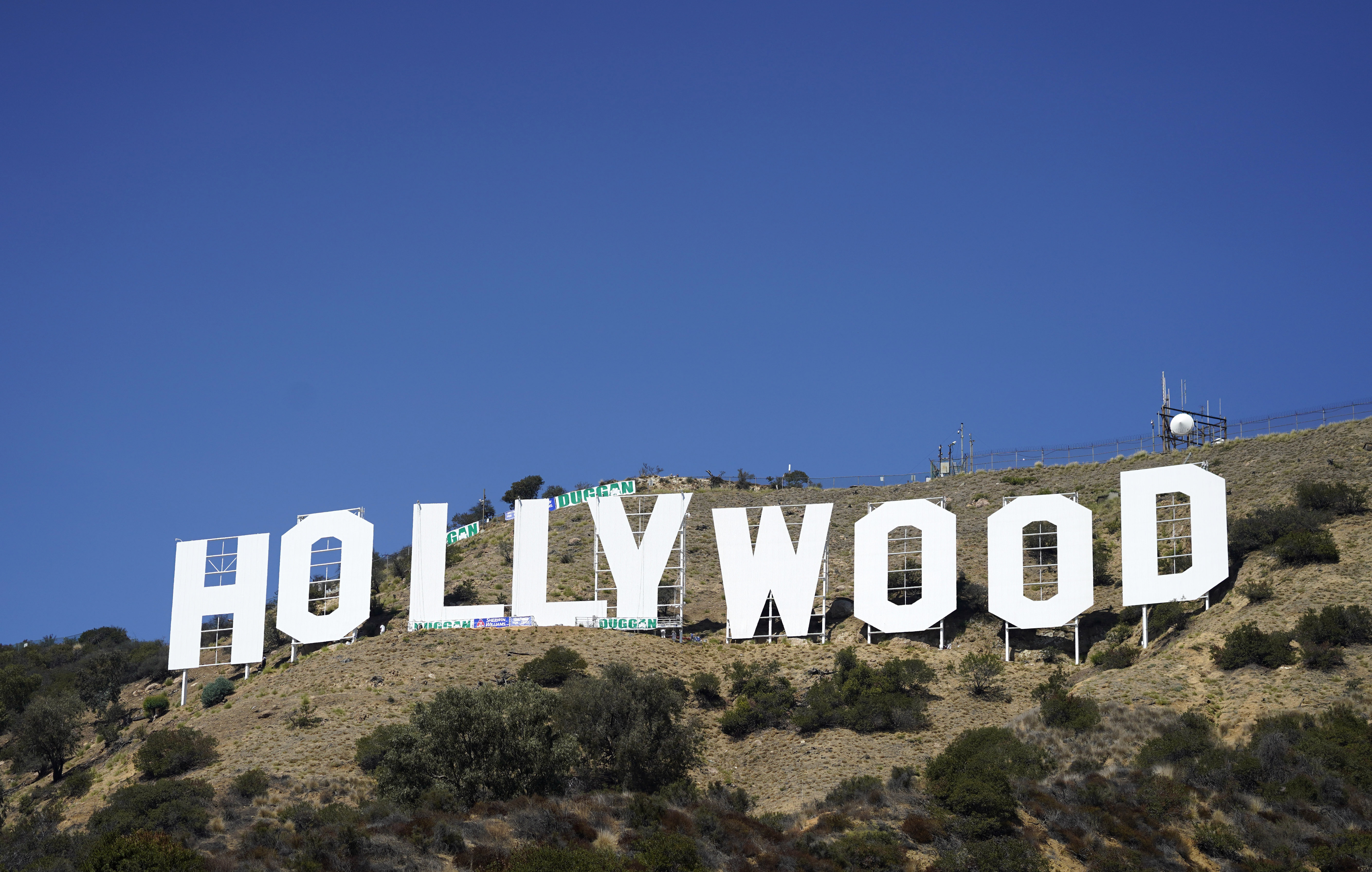 The Hollywood sign is pictured on Sept. 29 in Los Angeles. The Hollywood sign is getting a makeover befitting its status as a Tinseltown icon. After a pressure-wash and some rust removal, workers this week began using 250 gallons of primer and white paint to spruce up the sign ahead of its centennial next year. 