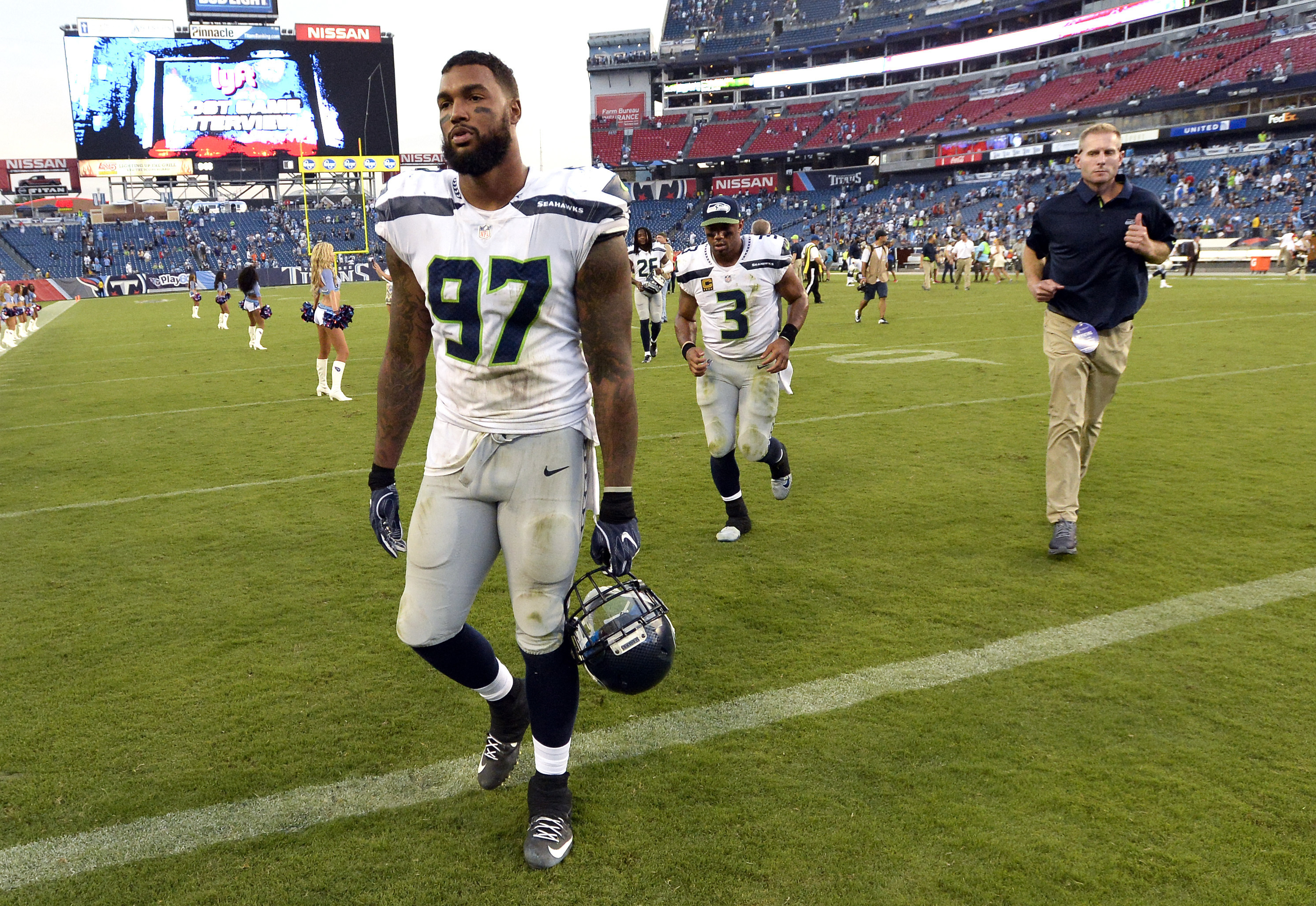 FILE - Seattle Seahawks defensive end Marcus Smith (97) and quarterback Russell Wilson (3) leave the field after an NFL football game against the Tennessee Titans Sunday, Sept. 24, 2017, in Nashville, Tenn. The Titans won 33-27. Smith, a 2014 first-round pick by the Philadelphia Eagles, is among many former and active NFL players who have shared their personal stories to break the stigma surrounding mental health and encourage people to seek help they need. 
