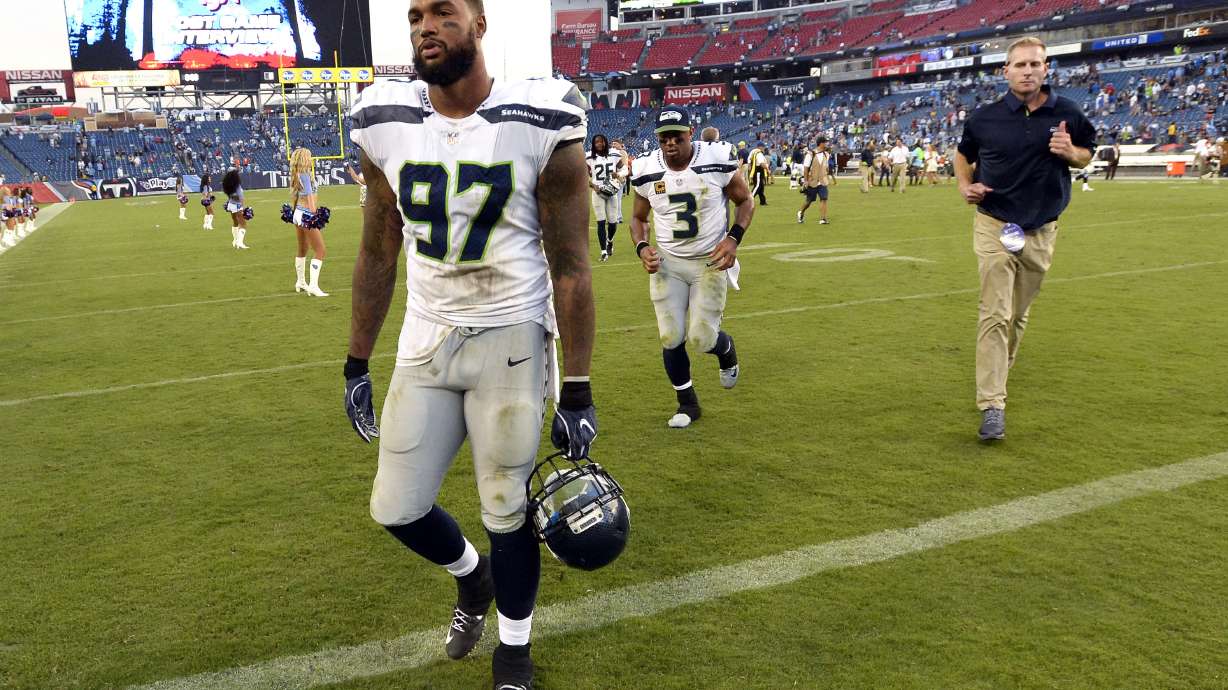 FILE - Seattle Seahawks defensive end Marcus Smith (97) and quarterback Russell Wilson (3) leave the field after an NFL football game against the Tennessee Titans Sunday, Sept. 24, 2017, in Nashville, Tenn. The Titans won 33-27. Smith, a 2014 first-round pick by the Philadelphia Eagles, is among many former and active NFL players who have shared their personal stories to break the stigma surrounding mental health and encourage people to seek help they need.