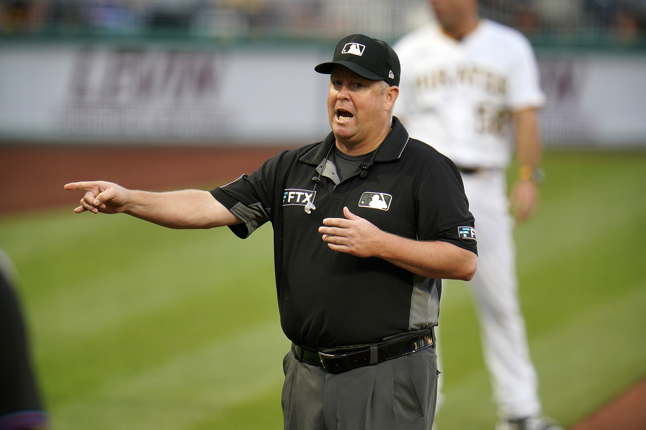 Umpire crew chief Todd Tichenor announces the outcome of a play review during a baseball game between the Pittsburgh Pirates and the Miami Marlins in Pittsburgh, Saturday, July 23, 2022. The notion of hearing a mic'd-up ump's voice explaining something feels oddly revolutionary, even after nearly an entire season of hearing it off and on.