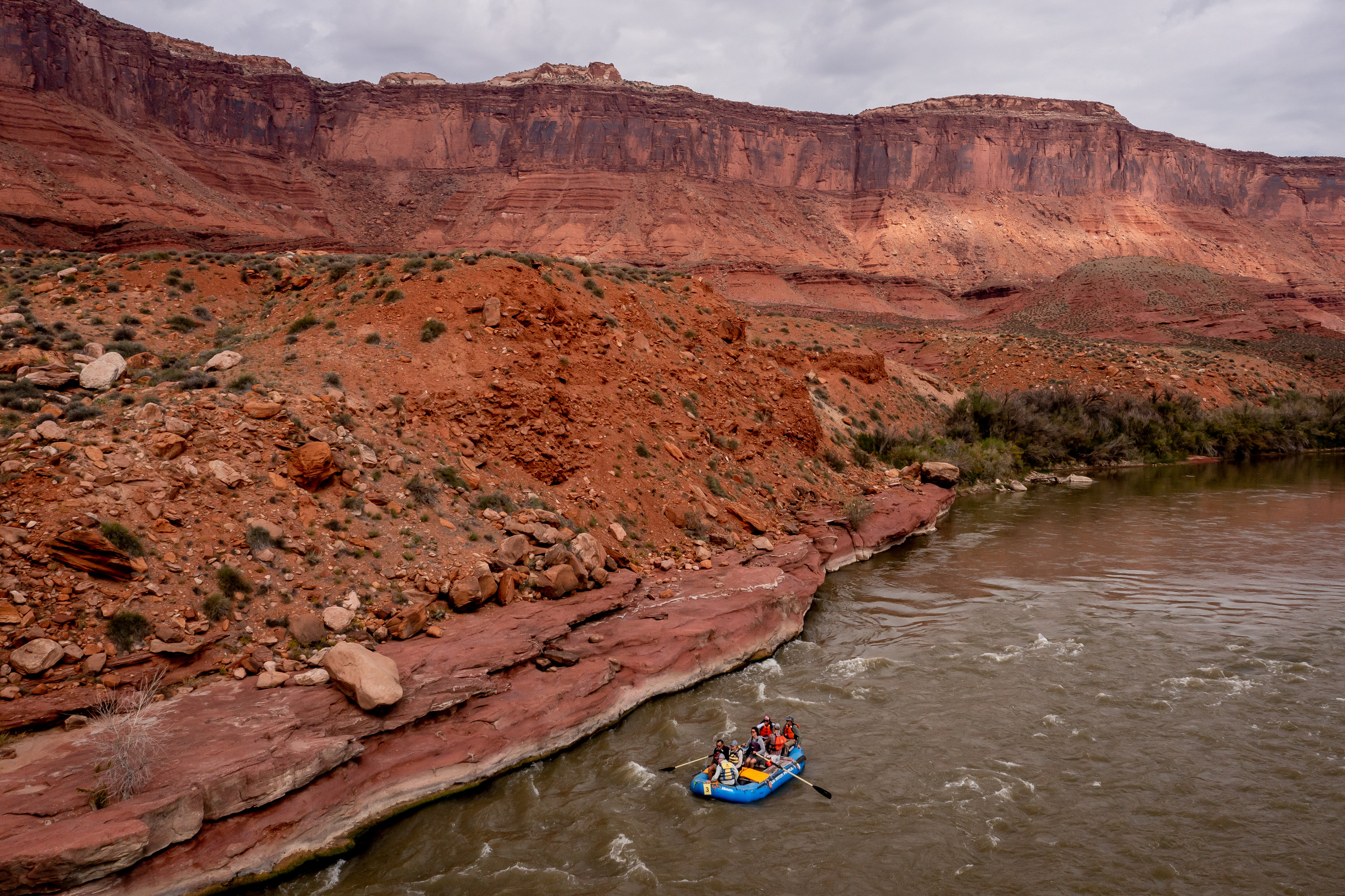 A raft carrying Sen. Mitt Romney, R-Utah, his wife, Ann, and Sen. Michael Bennet, D-Colo., floats down a section of the Colorado River northeast of Moab on Sept. 18. The river isn't just vital for eastern Utah, but most people living in the state, experts say.