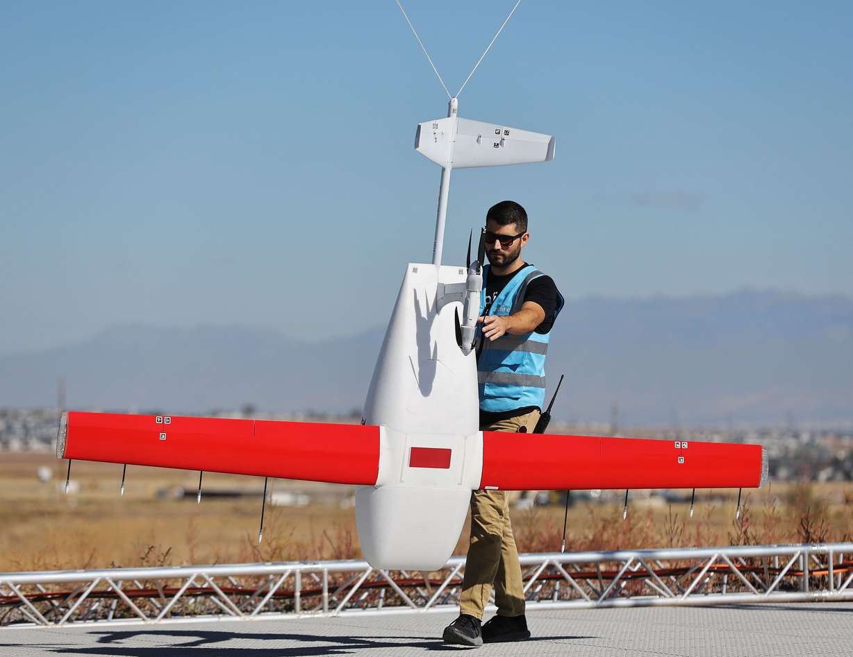 Zipline flight operator Chris Pfeifer approaches a drone after he landed it in South Jordan on Tuesday. Zipline and Intermountain Healthcare will begin drone deliveries for prescriptions and medical products in the Salt Lake Valley.
