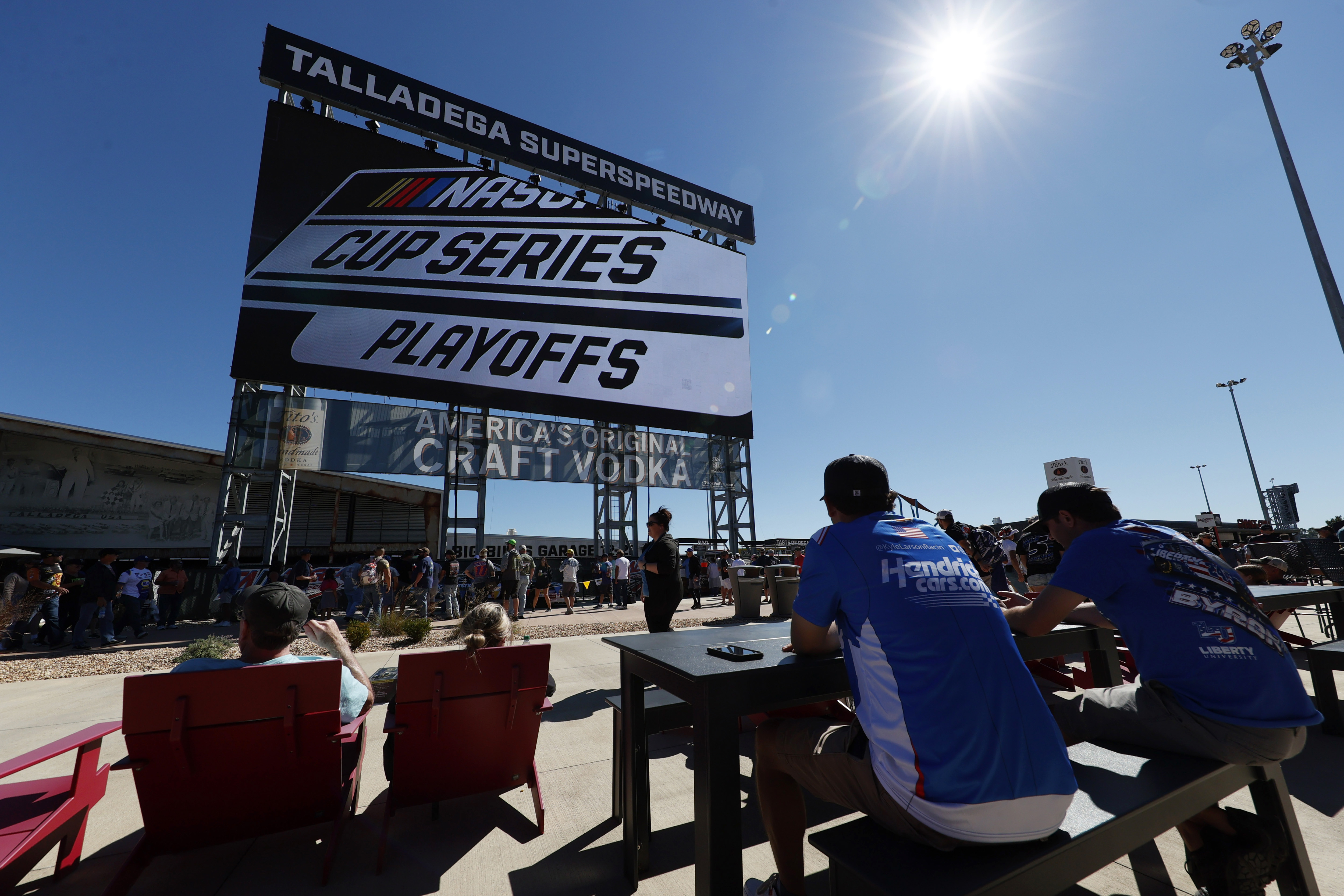 Fans eat and watch the big screen before the NASCAR Cup Series auto race Sunday, Oct. 2, 2022, in Talladega, Ala. 