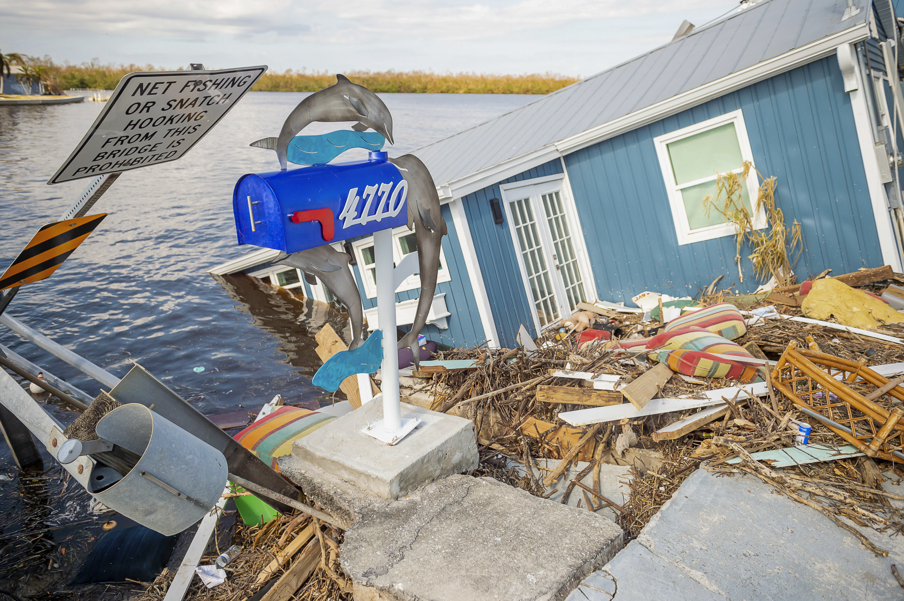 A residence sits partially submerged in water after Hurricane Ian leaves behind widespread damage across Pine Island, Fla., on Tuesday, Oct. 4, 2022. 