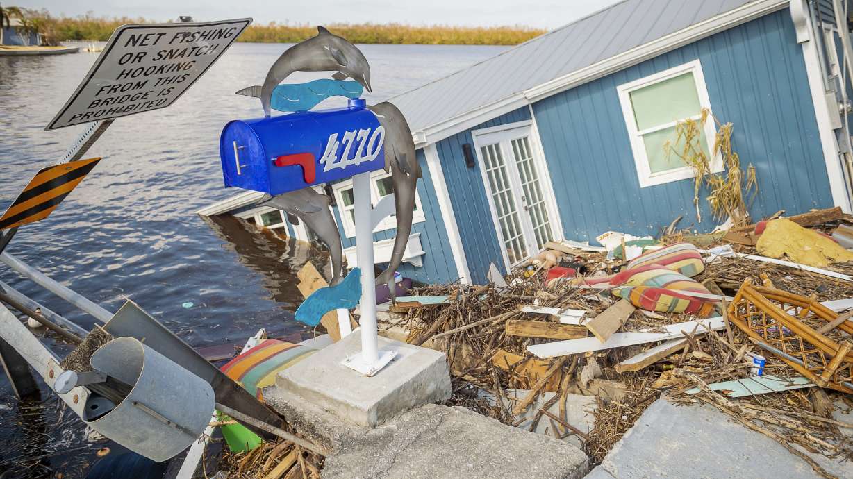 A residence sits partially submerged in water after Hurricane Ian leaves behind widespread damage across Pine Island, Fla., on Tuesday, Oct. 4, 2022.