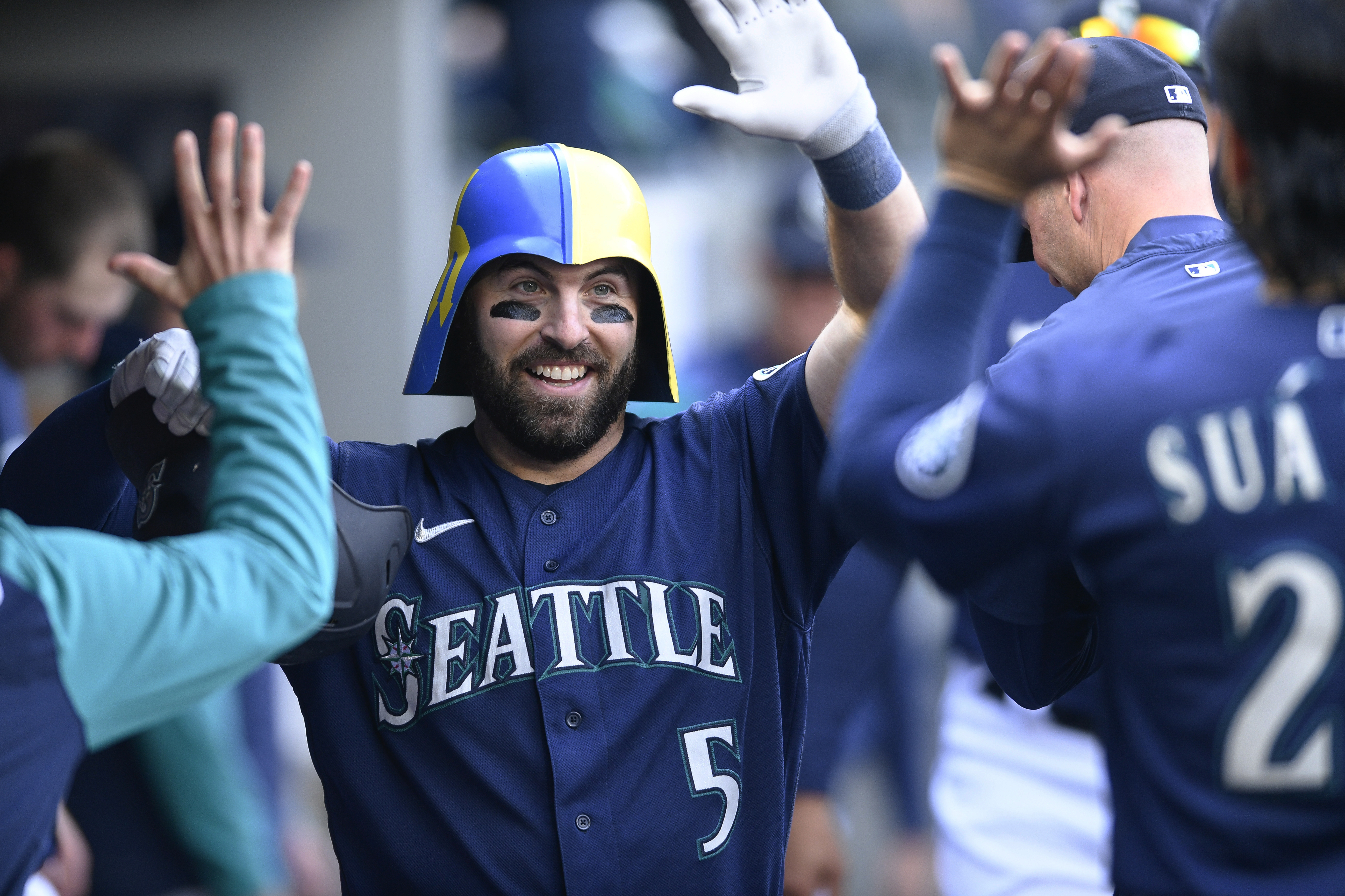 Seattle Mariners' Curt Casali celebrates in the dugout after his solo home run against the Detroit Tigers during the third inning of the first game of a baseball doubleheader Tuesday, Oct. 4, 2022, in Seattle. 
