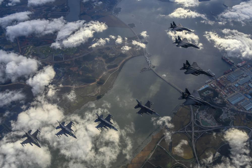 South Korean Air Force's F-15K fighter jets and U.S. Air Force's F-16 fighter jets, fly in formation during a joint drill in an undisclosed location in South Korea, Tuesday. The South Korean and U.S. militaries responded to a North Korea morning missile launch by launching fighter jets which fired weapons at a target off South Korea's west coast in a show of strength against North Korea.
