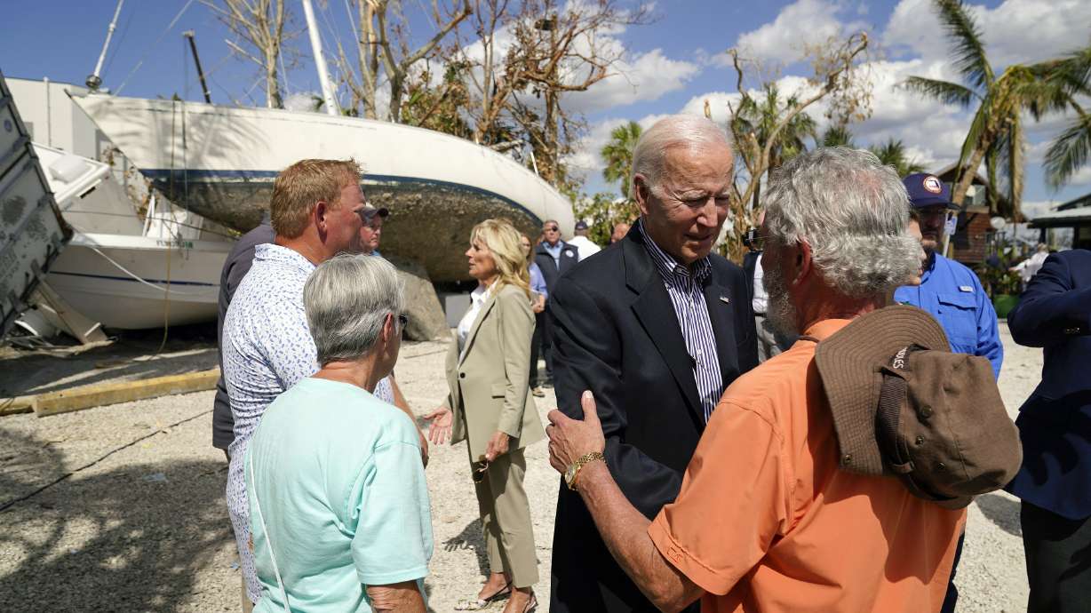 President Joe Biden and first lady Jill Biden talk to people impacted by Hurricane Ian during a tour of the area on Wednesday, in Fort Myers Beach, Fla.