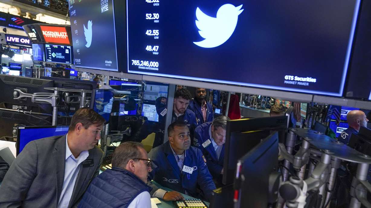 Traders gather around a post as Twitter shares resume trading on the floor at the New York Stock Exchange in New York on Tuesday.
